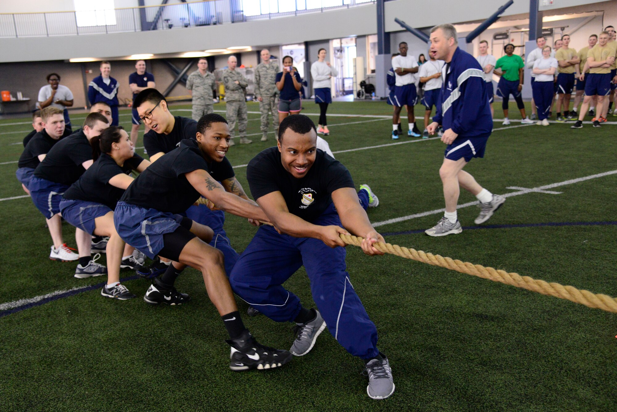 Wing Staff Agencies Airmen pull on a rope during a 354th Fighter Wing Sports Day tug-of-war competition at Eielson Air Force Base, Alaska, March 30, 2015. The event gave Airmen the opportunity to participate in several events throughout the day, boosting team morale. (U.S. Air Force photo by Senior Airman Racheal E. Watson/Released)