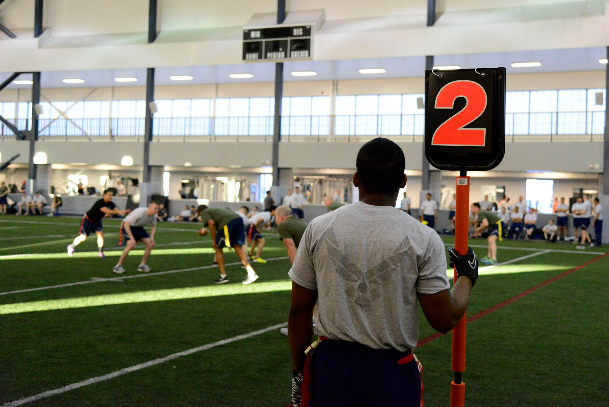 A U.S. Airman holds a down marker during a 354th Fighter Wing Sports Day football game at Eielson Air Force Base, Alaska, March 30, 2015. Sports Day was held to build teamwork, camaraderie and friendly competition among teams and units on base. (U.S. Air Force photo by Senior Airman Racheal E. Watson/Released)