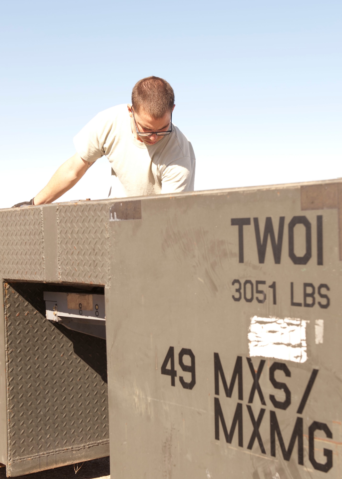 Senior Airman Scott Gray, 49th Maintenance Squadron Aerospace Ground Equipment journeyman, moves a load tester to be used on an MJ-1B/C Bomblift at Holloman Air Force Base, N.M. April 1, 2015. The load tester weighs 3,051 pounds and is designed to test the maximum load to be carried by a bomb lift. This test ensures the bomb lift is fully capable to handle the weight of any bomb or weapon being used. (U.S. Air Force photo by Staff Sgt. E’Lysia A. Wray/Released)