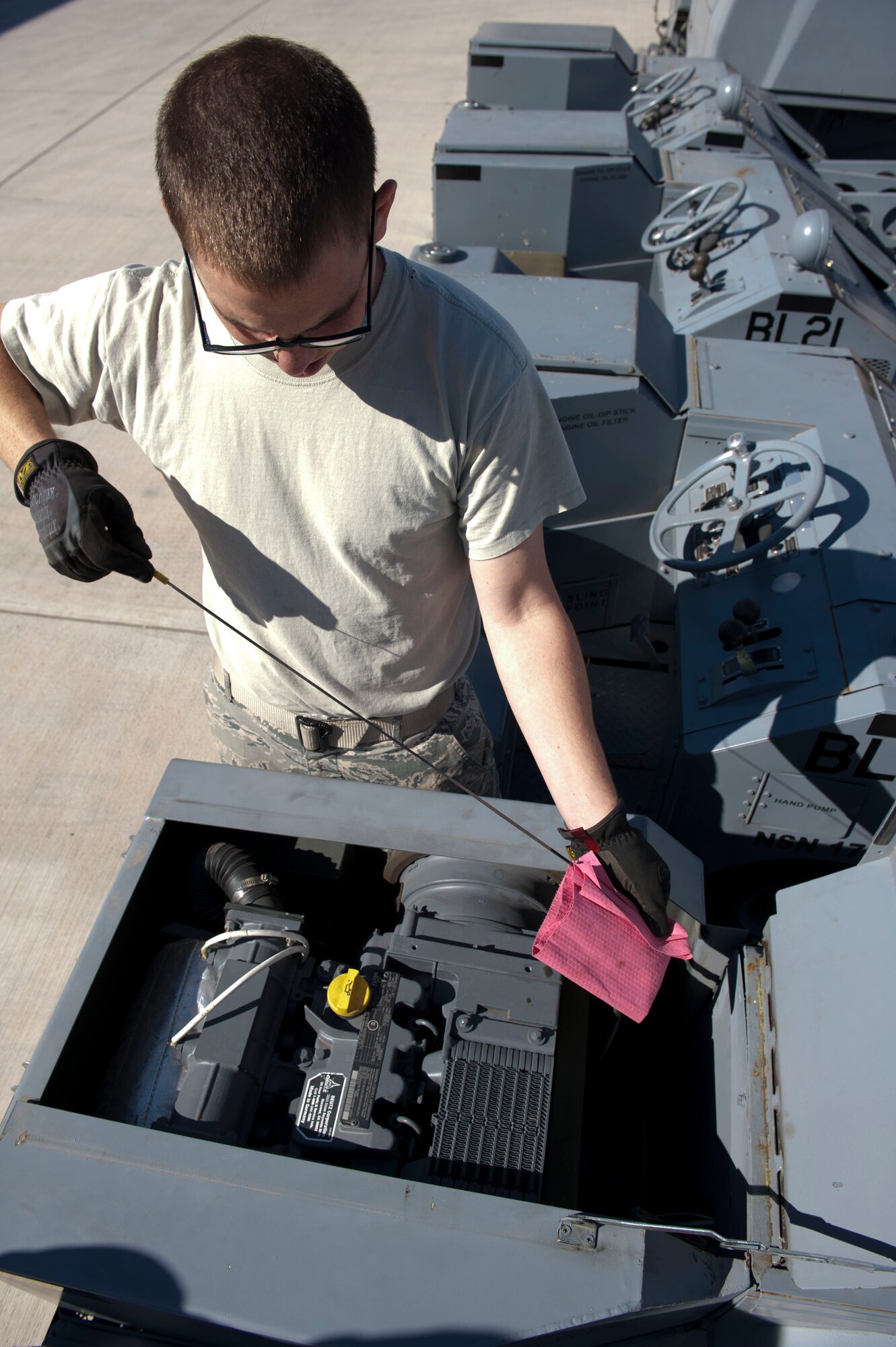 Senior Airman Scott Gray, 49th Maintenance Squadron Aerospace Ground Equipment journeyman, checks the oil level on a MJ1-B/C Bomblift, known throughout the Air Force as a jammer, during a service inspection at Holloman Air Force Base, N.M. April 1, 2015. Service inspections are completed by checking fluid levels, checking for any loose or missing hardware, and to ensure the piece of equipment is safe for usage. (U.S. Air Force photo by Staff Sgt. E’Lysia A. Wray/Released)