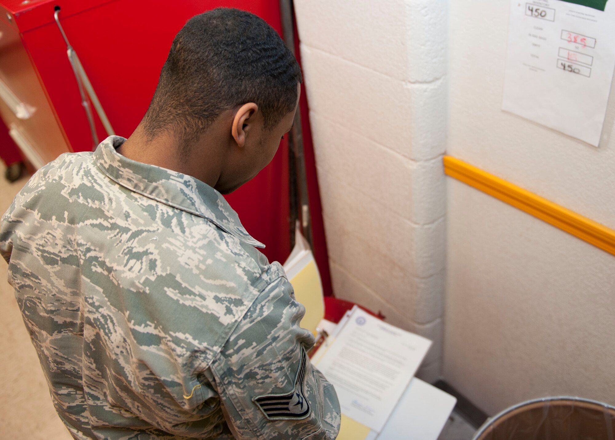 Staff Sgt. Brian Robinson, 49th Maintenance Squadron Aerospace Ground Equipment craftsman, takes inventory of used rags and spill pads at Holloman Air Force base, N.M. April 1, 2015. Maintaining accountability of materials is essential to the success of the Foreign Object Damage program, which ensures rags and spill pads do not get caught in the intake of aircraft and cause major damage. (U.S. Air Force photo by Staff Sgt. E’Lysia A. Wray/Released)