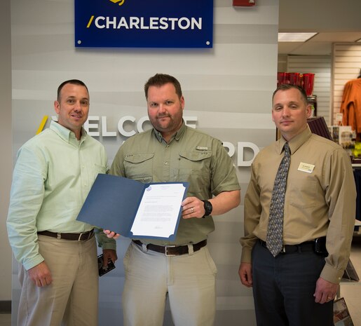 Blair Smith, a Constable for Berkeley County, received a letter of appreciation from (left) Alex Schmidt, Naval Exchange loss prevention manager and Ken Bingham, NEX general manager on March 31, 2015, at the NEX on Naval Weapons Station Charleston, S.C. Smith apprehended a shoplifter who was responsible for over $1000 worth of stolen NEX merchandise. According to NEX officials, if it weren’t for Smith, the store would have incurred much greater losses. (U.S. Air Force photo/Airman 1st Class Clayton Cupit)