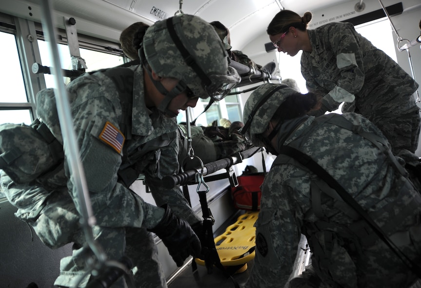 Guam Army National Guard medical detachment soldiers secure a patient on a bus for transport during the Operation Joint Medic training exercise March 31, 2015, at Silver Flag Alpha range complex, Nevada. Approximately 80 Air Force Reserve and U.S. Army National Guard personnel participated in the event, which is a medical readiness training exercise designed to exercise combat casualty care skills in a realistic setting. (U.S. Air Force photo by Airman 1st Class Christian Clausen/Released)