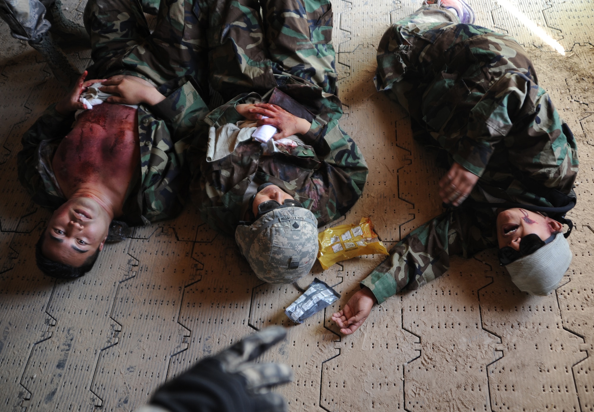 Simulated casualties talk to the independent duty medical technicians during the Operation Joint Medic training exercise March 31, 2015, at Silver Flag Alpha range complex, Nevada. This inaugural exercise provided joint service training in preparation of full spectrum downrange medical operations. (U.S. Air Force photo by Airman 1st Class Christian Clausen/Released)