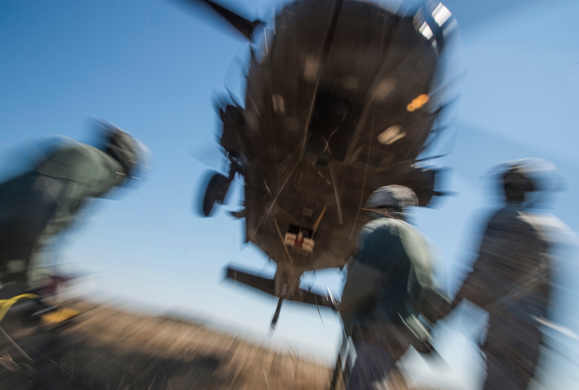 Airmen from the 621st Contingency Response Wing attempt to hook up cargo to a U.S. Army UH-60 Black Hawk helicopter from the 1-150th Assault Helicopter Battalion during sling-load training at Joint Base McGuire-Dix-Lakehurst, N.J., April 1, 2015. The training allows the Army pilots and crew members and Air Force Airmen to stay proficient with sling-load operations. (U.S. Air Force photo/Staff Sgt. Gustavo Gonzalez/RELEASED)