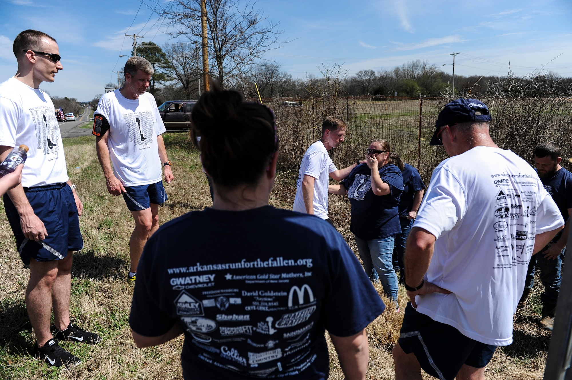 A gold-star mother is consoled by an Arkansas Run for the Fallen team member March 20, 2015, outside of Clarksville, Ark., March 20, 2015. Every mile, for 146 miles, a member of the running group read the biography card, placed it in the ground at the designated memorial site for the fallen service member and rendered a salute. (U.S. Air Force photo/Senior Airman Cliffton Dolezal)