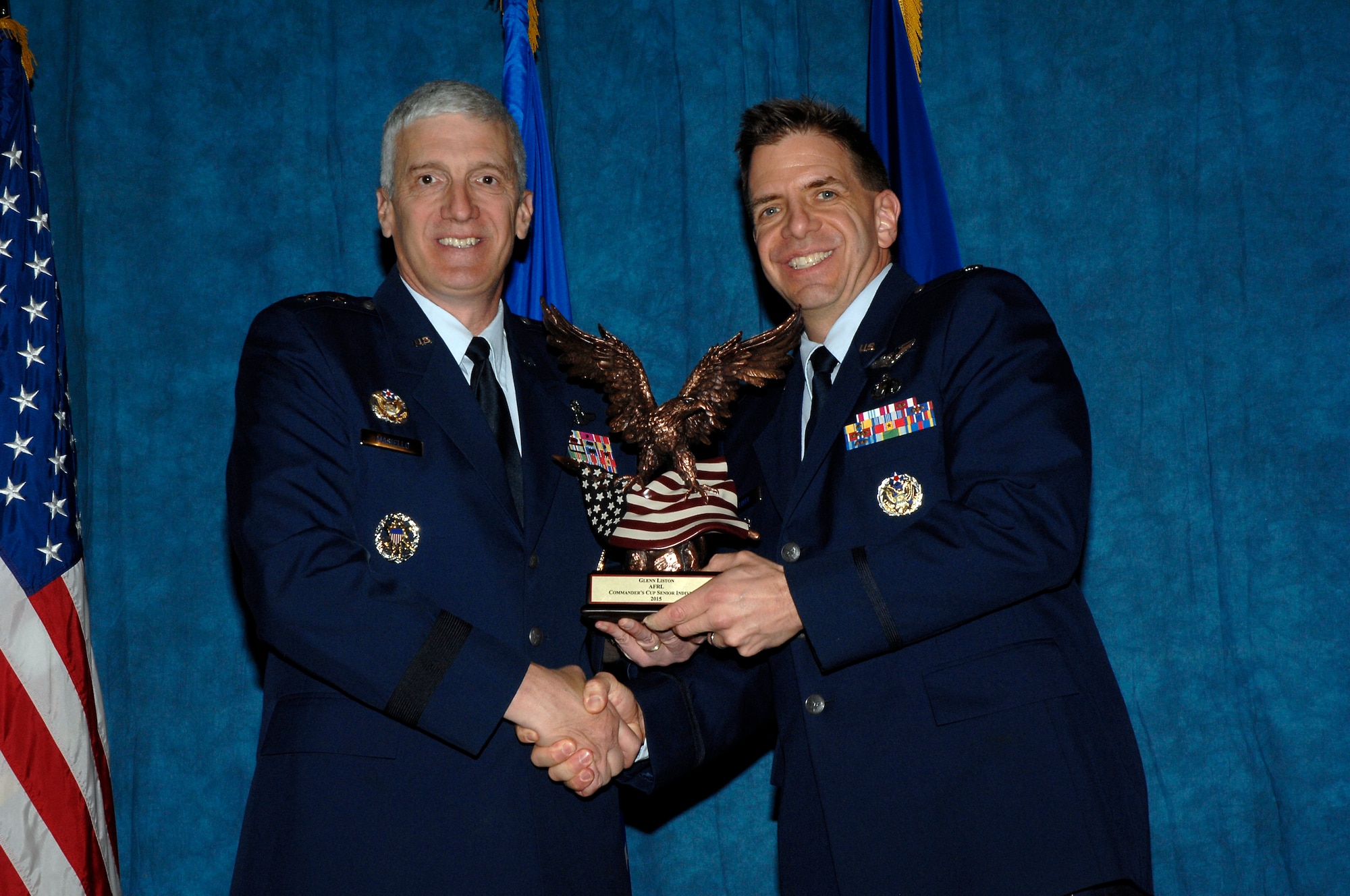 Maj. Gen. Tom Masiello, AFRL commander, presents Glenn Liston with a Commander’s Cup (Senior Individual) award during the 2015 AFRL Annual Awards ceremony. (U.S. Air Force photo by Albert Bright)