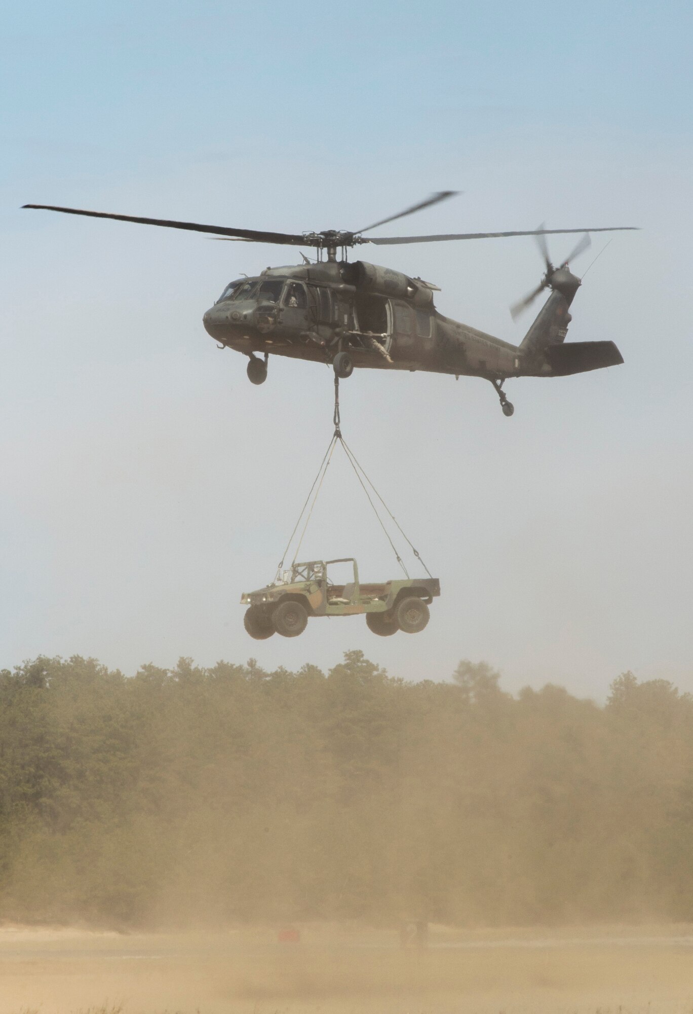 A U.S. Army UH-60 Black Hawk helicopter from the 1-150th Assault Helicopter Battalion lifts a vehicle during sling-load training with the 621st Contingency Response Wing at Joint Base McGuire-Dix-Lakehurst, N.J., April 1, 2015. The training is conducted on a monthly basis. (U.S. Air Force photo/Staff Sgt. Gustavo Gonzalez/RELEASED)