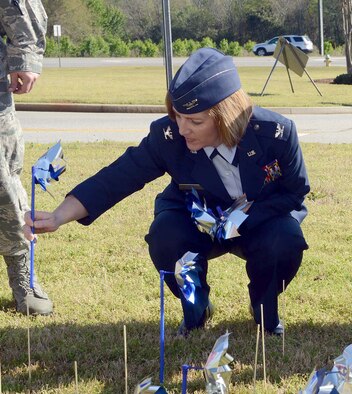 Col. Dawn Lancaster, 78th Air Base Wing vice commander, plants pinwheels Wednesday as part of the Child Abuse Prevention Month kickoff event at the Houston County Courthouse in Perry. During the month the pinwheels, which represent childhood innocence, will be rotated to locations around the county. (U.S. Air Force photo by Tommie Horton)