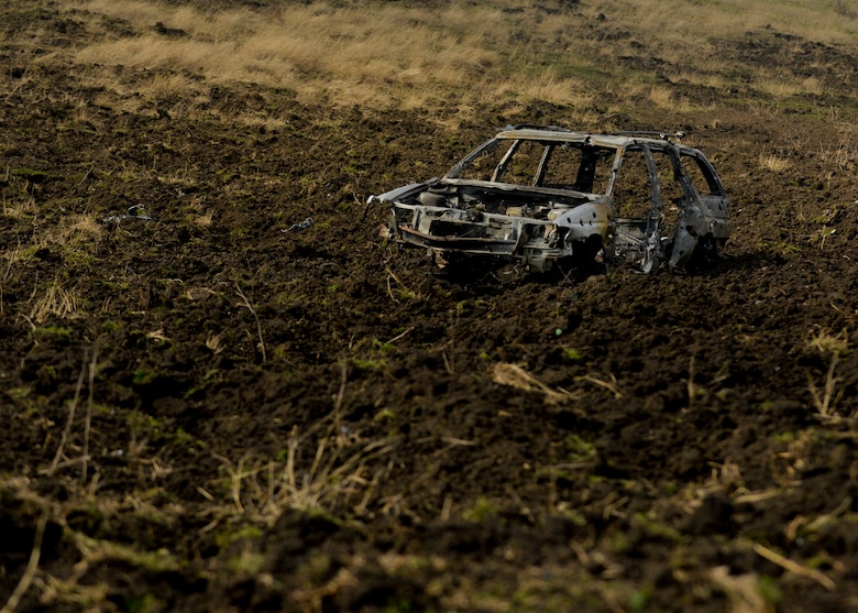 A dummy vehicle displays damage caused from rounds fired from a30mm GAU-8 Avenger rotary cannon on a U.S. Air Force A-10 Thunderbolt II assigned to the 354th Expeditionary Fighter Squadron during a theater security package deployment over the range at Campia Turzii, Romania, April 1, 2015. The pilots used the car as a target for the U.S. and Romanian air forces while aiming to strengthen interoperability and demonstrate the countries' shared commitment to the security and stability of Europe.  (U.S. Air Force photo by Staff Sgt. Joe W. McFadden/Released)