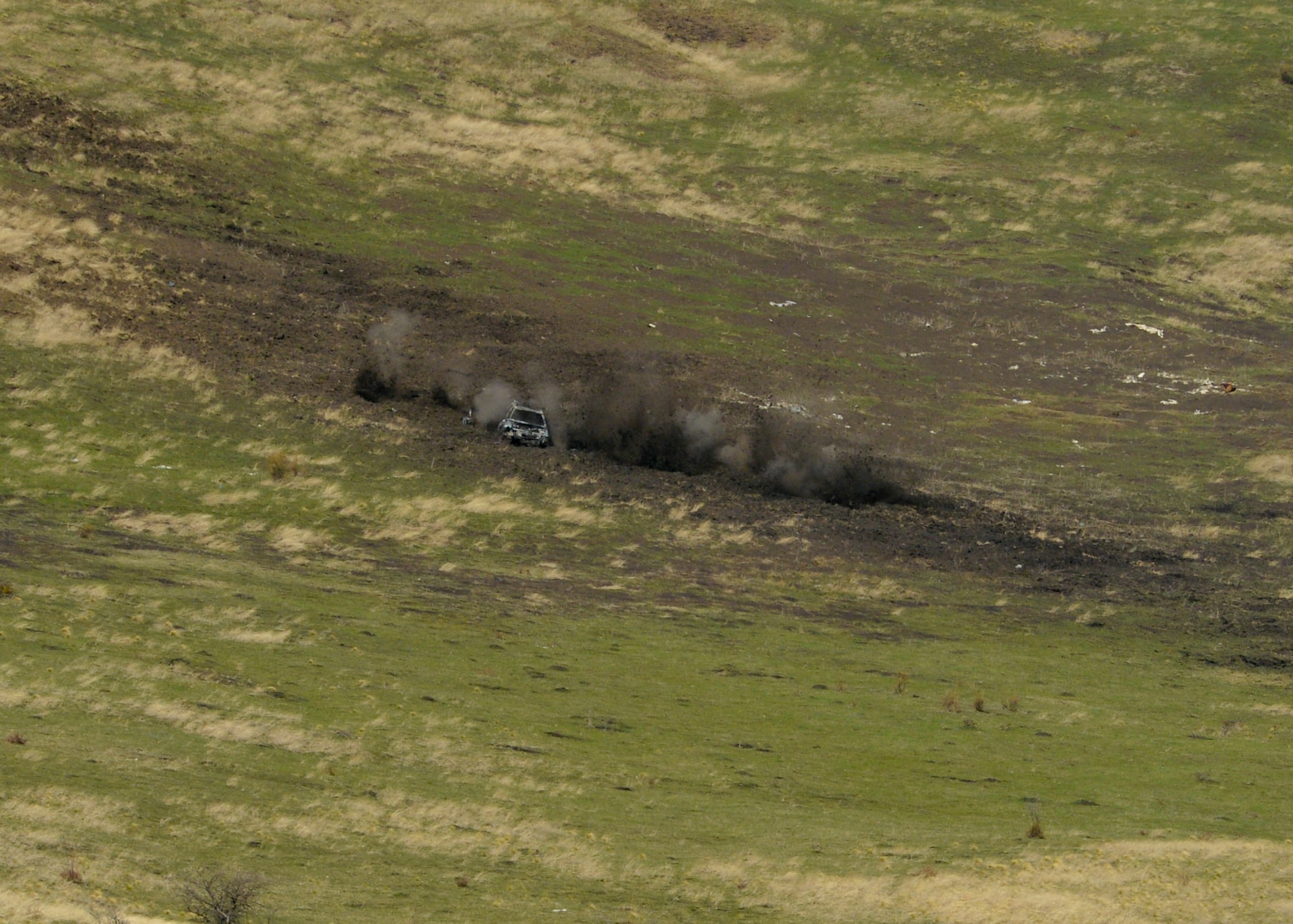 A dummy vehicle and its surrounding area is impacted by rounds fired from a 30mm GAU-8 Avenger rotary cannon on a U.S. Air Force A-10 Thunderbolt II assigned to the 354th Expeditionary Fighter Squadron during a theater security package deployment at the range at Campia Turzii, Romania, April 1, 2015. The U.S. and Romanian air forces will conduct training aimed to strengthen interoperability and demonstrate the countries' shared commitment to the security and stability of Europe.  (U.S. Air Force photo by Staff Sgt. Joe W. McFadden/Released)