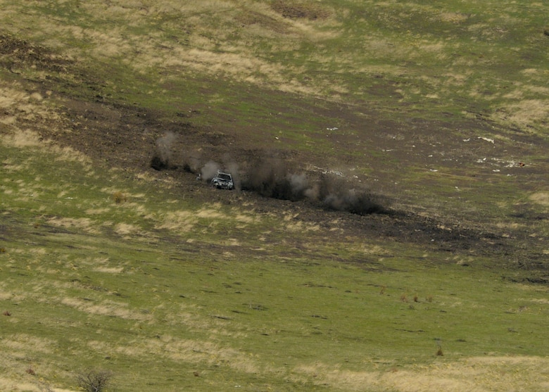 A dummy vehicle and its surrounding area is impacted by rounds fired from a 30mm GAU-8 Avenger rotary cannon on a U.S. Air Force A-10 Thunderbolt II assigned to the 354th Expeditionary Fighter Squadron during a theater security package deployment at the range at Campia Turzii, Romania, April 1, 2015. The U.S. and Romanian air forces will conduct training aimed to strengthen interoperability and demonstrate the countries' shared commitment to the security and stability of Europe.  (U.S. Air Force photo by Staff Sgt. Joe W. McFadden/Released)