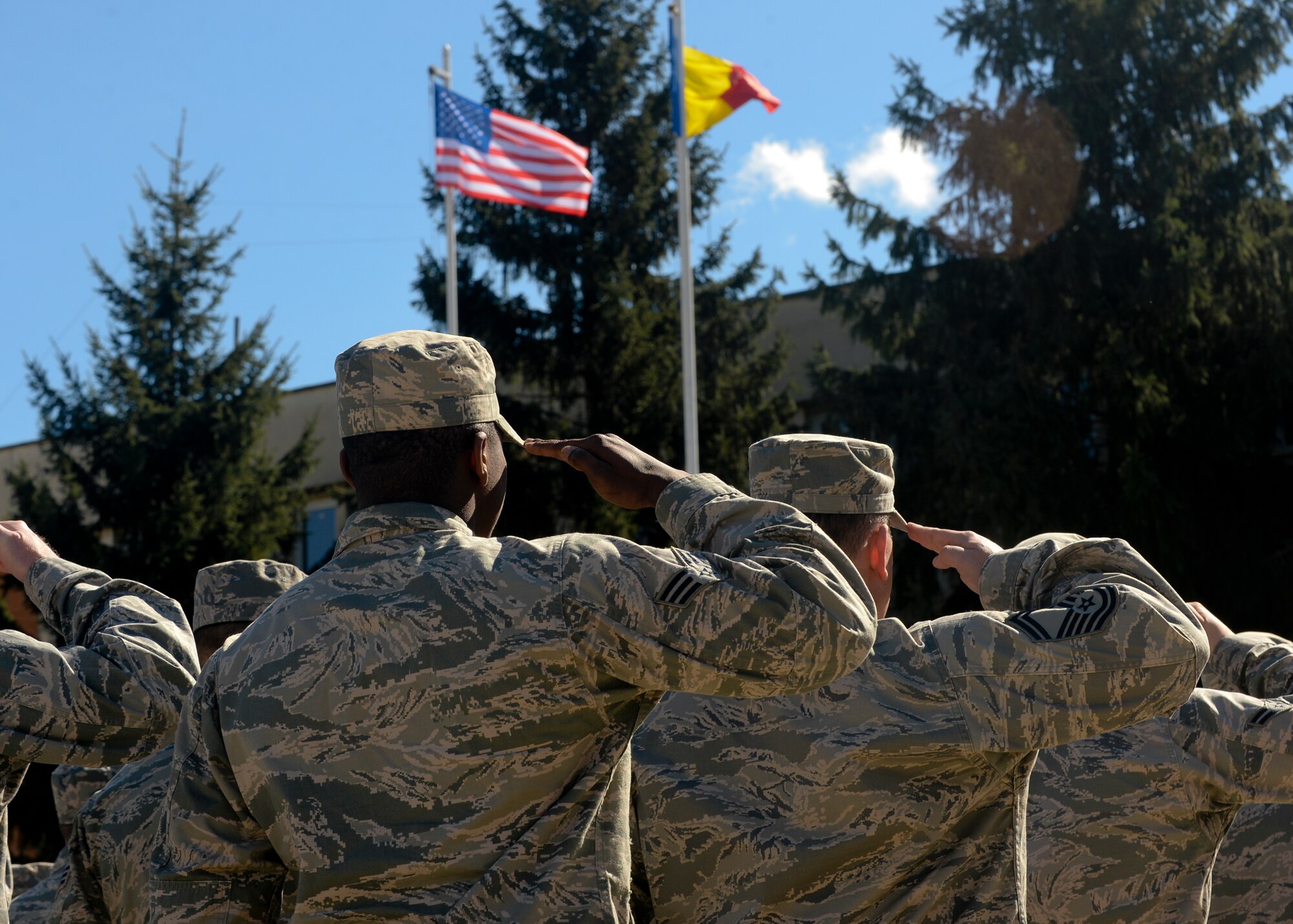 A flight of U.S. Air Force Airmen salute the U.S. and Romanian flags during the opening ceremony of Dacian Thunder 2015 at Campia Turzii, Romania, April 1, 2015. The U.S. and Romanian air forces will conduct training aimed to strengthen interoperability and demonstrate the countries' shared commitment to the security and stability of Europe.  (U.S. Air Force photo by Staff Sgt. Joe W. McFadden/Released)

