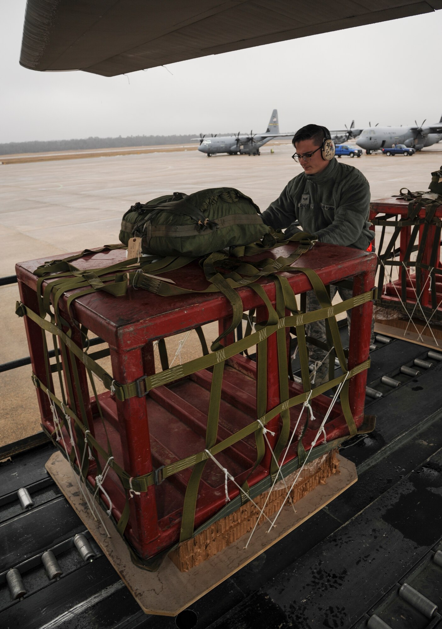 Senior Airman Zachary Arnold, a 19th Logistics Readiness Squadron air transportation specialist, loads a container deliver system onto a C-130J March 9, 2015, at Little Rock Air Force Base, Ark. The cargo pallet was dropped as part of a local aerial delivery exercise. (U.S. Air Force photo by Airman 1st Class Harry Brexel)  