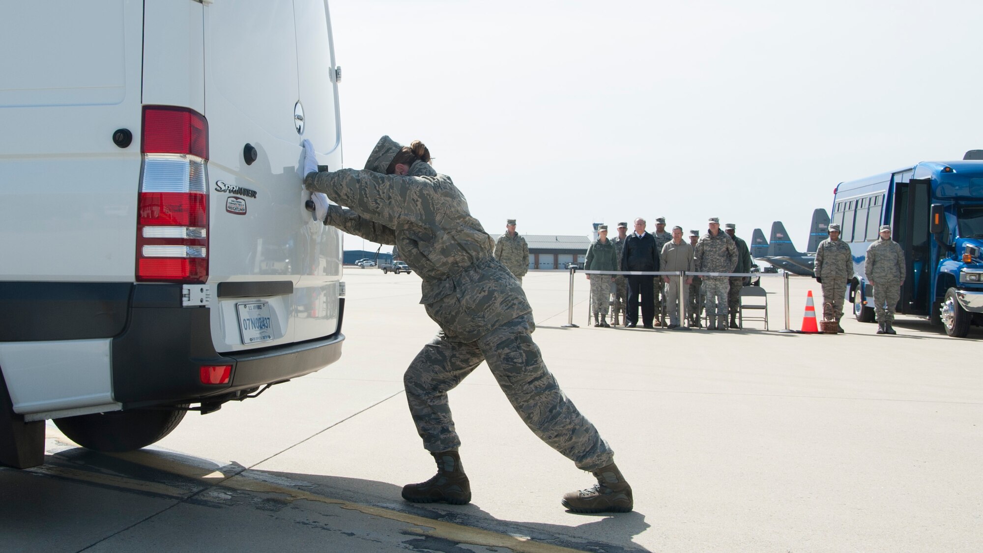 Senior Airman Jamie Debbrecht, a 512th Memorial Affairs Squadron services specialist, practices her role as door guard prior to the start of a dignified transfer divert exercise March 19, 2015, at New Castle Air National Guard Base, Del. Debbrecht is deployed to Air Force Mortuary Affairs Operations from the 512th Memorial Affairs Squadron, Dover Air Force Base, Del. (U.S. Air Force photo/Senior Airman Jared Duhon)