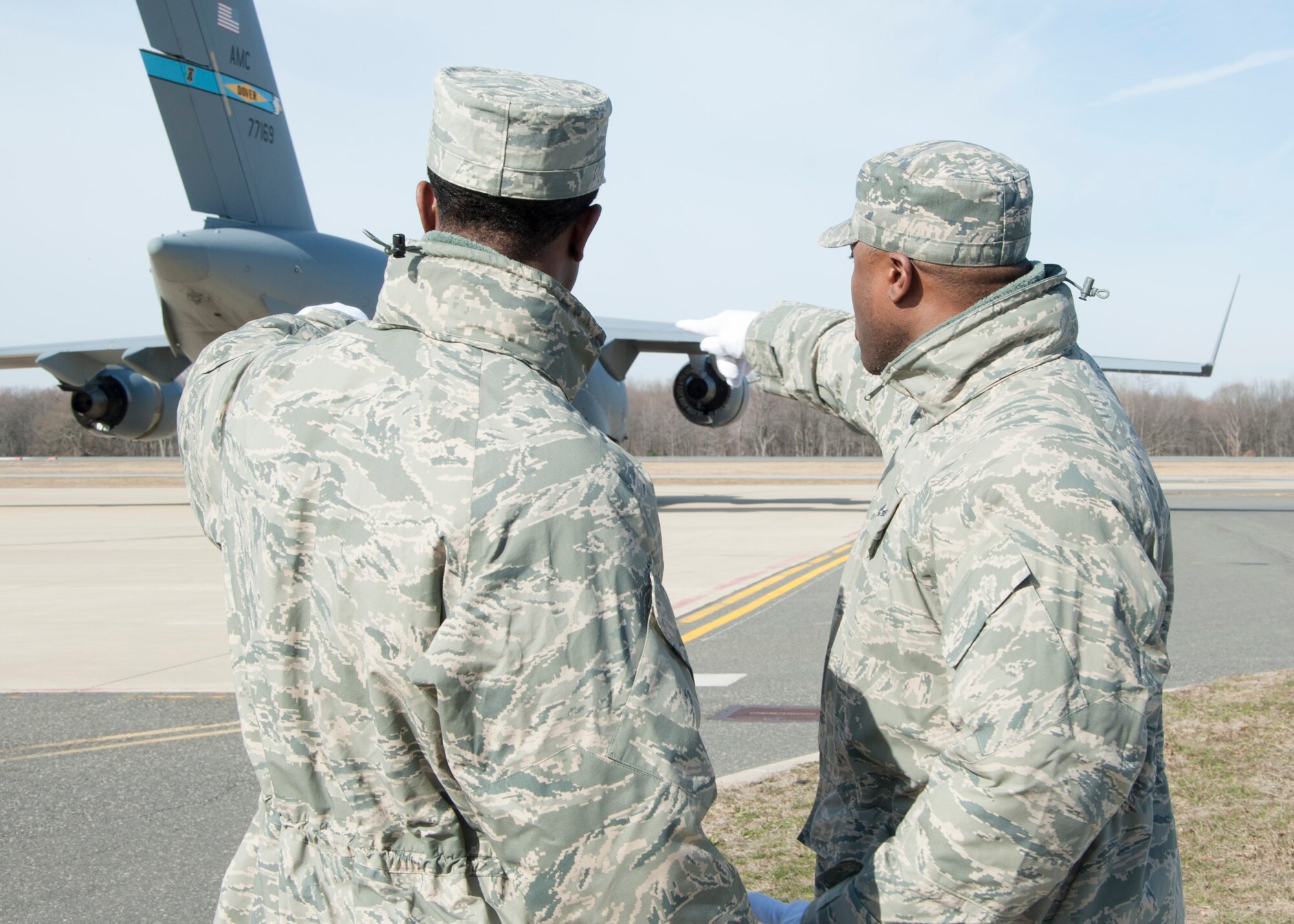 Senior Airman Omar Hall (right), provides coaching to first-time AFMAO deployer Senior Airman Marcus Wesley during a dignified transfer divert exercise March 19, 2015, at New Castle Air National Guard Base, Del. Hall has deployed to the mortuary five times and served as a carry team member for dignified transfers more than 100 times while Wesley has served as a carry team member three times. Both reservists are assigned to the 512th Memorial Affairs Squadron, Dover Air Force Base, Del. (U.S. Air Force photo/Senior Airman Jared Duhon)