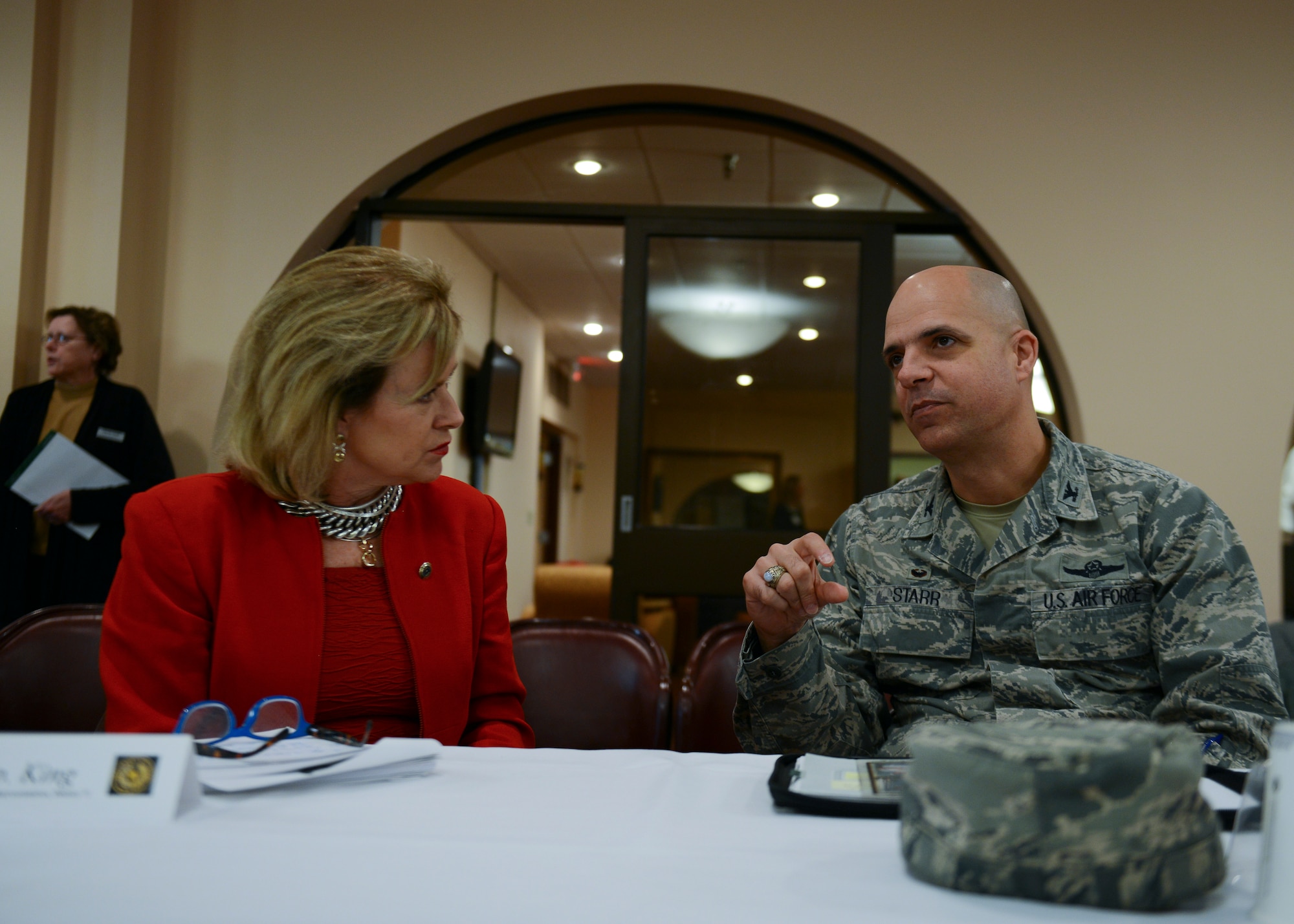 U.S. Air Force Col. Michael Bob Starr, 7th Bomb Wing commander, talks with Texas Rep. Susan King during the Public-Public-Public-Private (P4) Initiative meeting Dec. 10, 2014, at Dyess Air Force Base, Texas. The Air Force-led program helps organize partnerships between its bases and the communities, with which they are located, in an effort to share resources and save the Air Force money. (U.S. Air Force photo by Airman 1st Class Kedesha Pennant/Released)

