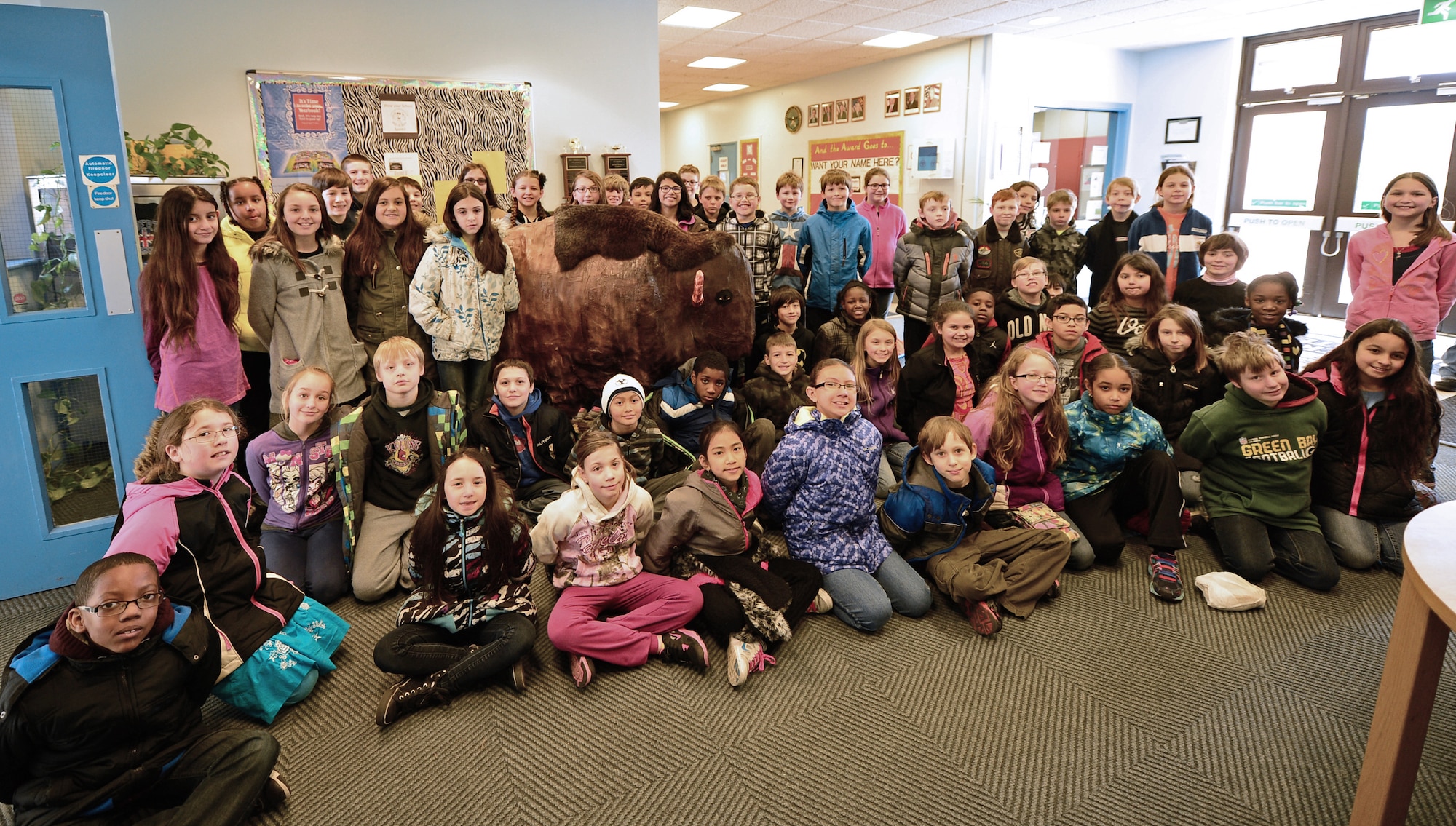 Liberty Intermediate School 4th and 5th grade students pose around the life-size bison they made from paper-mache at Royal Air Force Lakenheath, England, March 27, 2015. The students participated in a three-week project to learn about and experience colonial life. (U.S. Air Force photo by Airman 1st Class Erin R. Babis/Released)