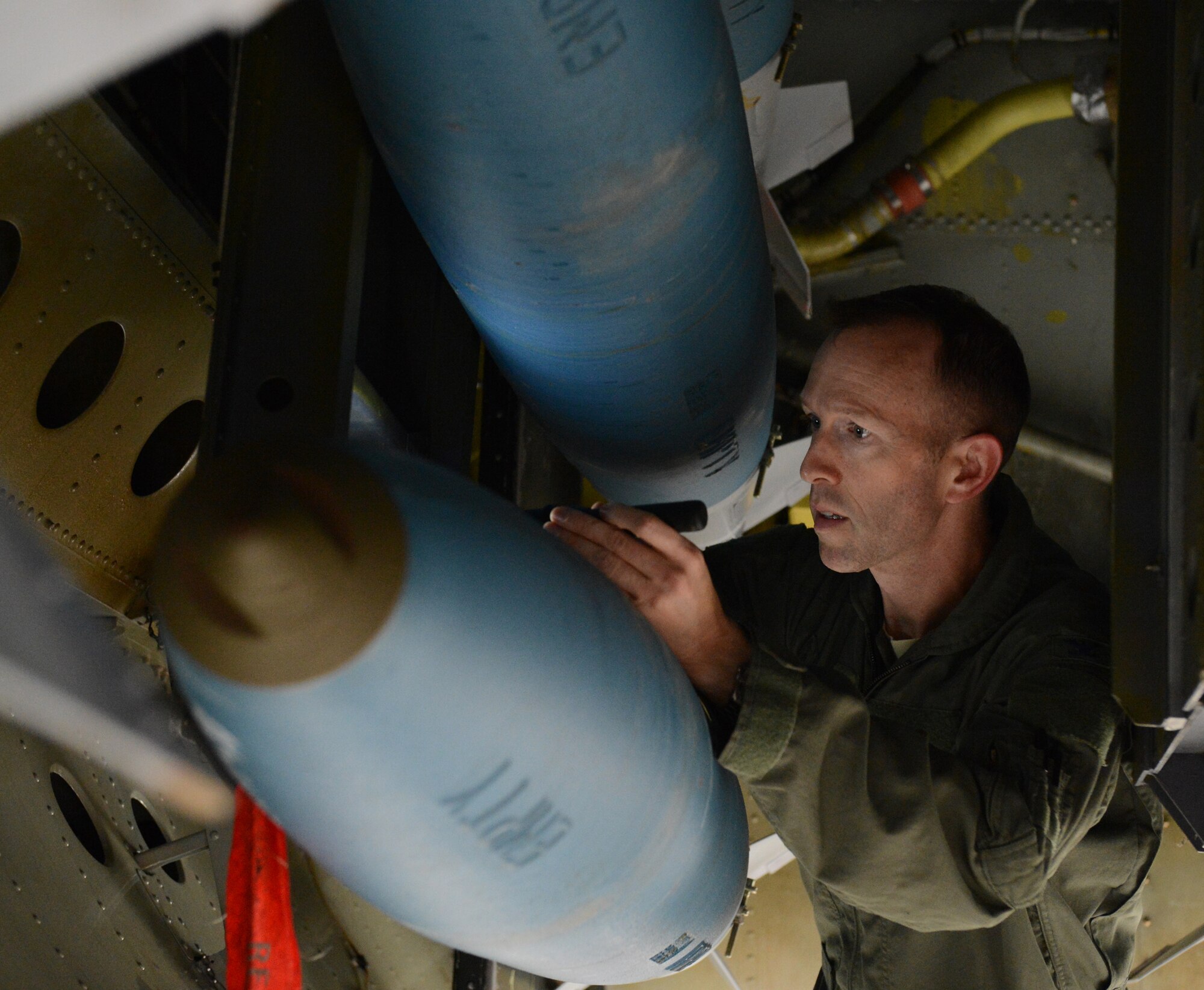 Col. Leland Bohannon, 2nd Bomb Wing vice commander, inspects an inert BDU-50 inside a B-52H Stratofortress bomb bay on Barksdale Air Force Base, La., April 1, 2015. The bombs are inspected to ensure they are properly connected to the aircraft. (U.S. Air Force photo/Senior Airman Benjamin Gonsier)