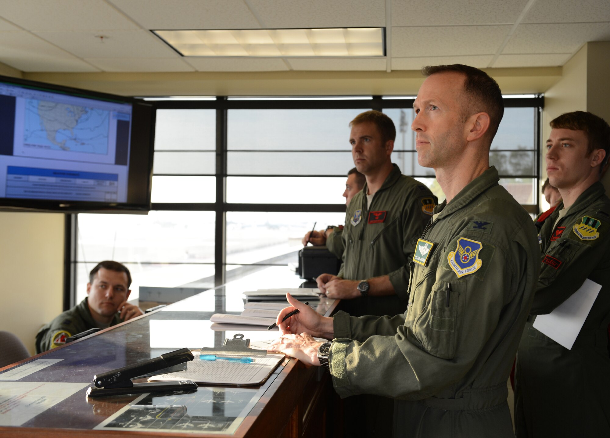 Col. Leland Bohannon, 2nd Bomb Wing vice commander, receives a mission briefing on Barksdale Air Force Base, La., April 1, 2015. During their session, aircrew members were briefed on weather conditions, where their aircraft is parked and filed paperwork. (U.S. Air Force photo/Senior Airman Benjamin Gonsier)