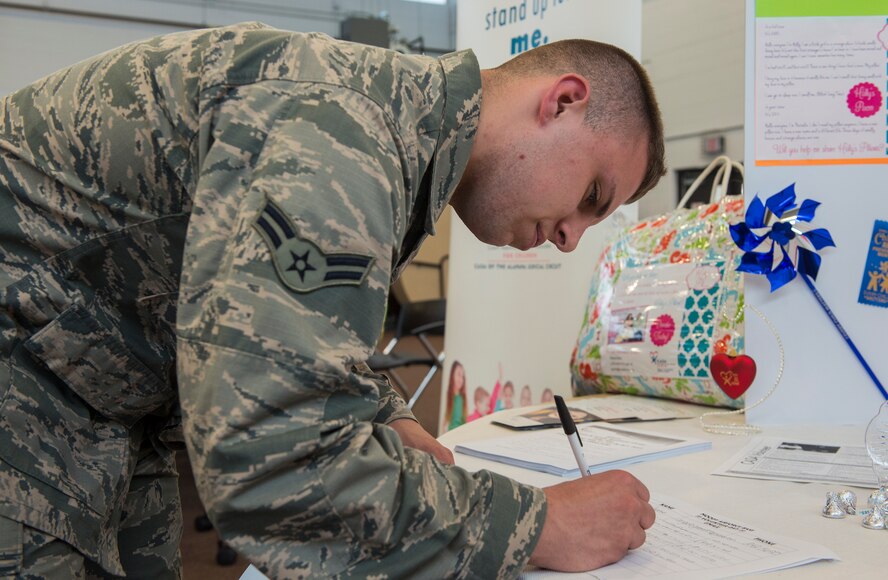 U.S. Air Force Airman 1st Class Cody Masterson, 23d Logistics Readiness Squadron material management specialist, signs up to volunteer during the Volunteer Fair April 1, 2015, at Moody Air Force Base, Ga. The different volunteer options available were a combination of organizations on base and in the local area. (U.S. Air Force photo by Airman 1st Class Ceaira Tinsley/Released)