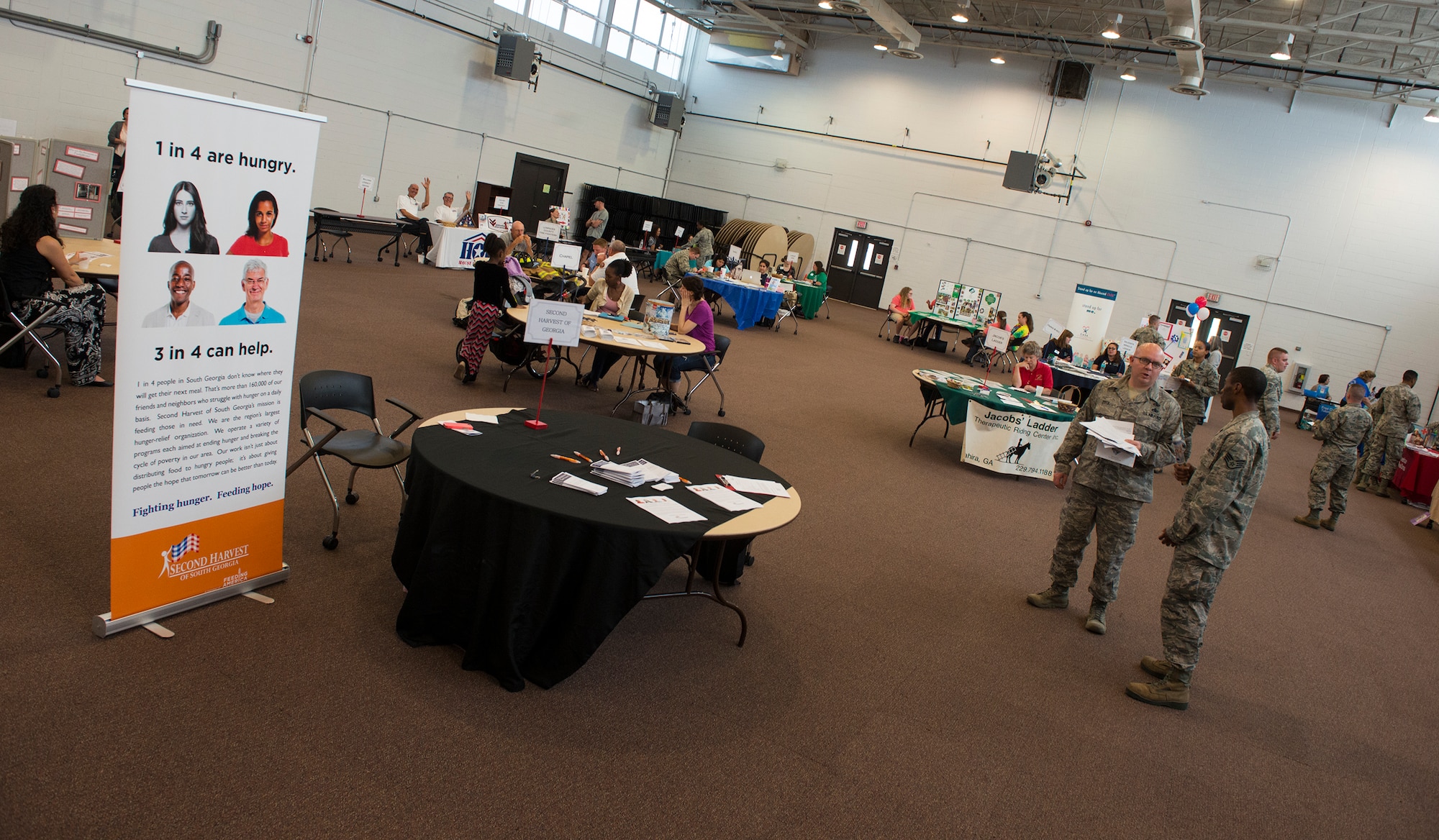 Guests in attendance mingle during the Volunteer Fair April 1, 2015, at Moody Air Force Base, Ga. The volunteer fair brought together 22 various organizations to make it easier for Team Moody members to learn the different volunteer opportunities available to them. (U.S. Air Force photo by Airman 1st Class Ceaira Tinsley/Released)