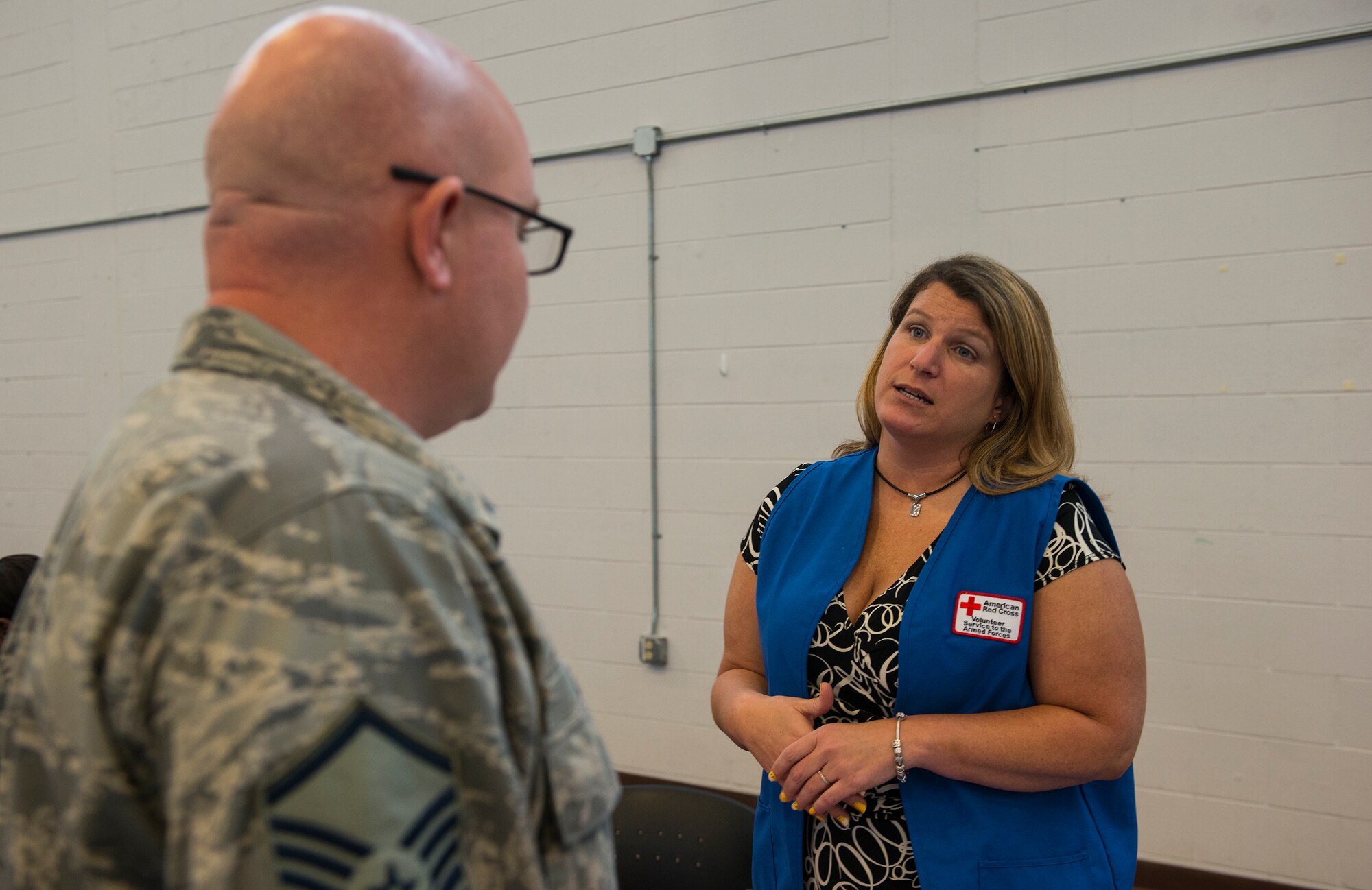 Talia Eltzroth, American Red Cross Association volunteer, shares her beliefs on the importance of volunteerism with U.S. Air Force Master Sgt. Nicholas Zeece, 23d Logistics Readiness Squadron vehicle management section chief, during the Volunteer Fair April 1, 2015, at Moody Air Force Base, Ga. The goal of the fair was to increase volunteerism among Team Moody members. (U.S. Air Force photo by Airman 1st Class Ceaira Tinsley/Released)