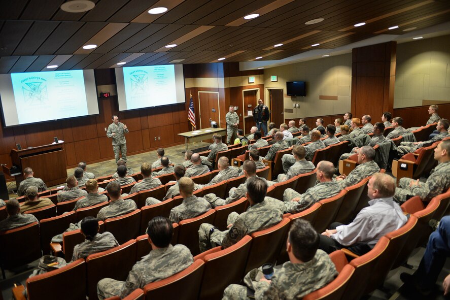 Col. Kevin Kennedy 28th Bomb Wing commander, addresses Airmen during an annual preseason Motorcycle Safety Briefing in the Deployment Center at Ellsworth Air Force Base, S.D., March 25, 2015. In accordance with Air Force Instruction 91-207, Motor Vehicle Safety Standards, motorcycle riders must attend a yearly briefing which includes safe riding instruction in an effort to minimize risks. (U.S. Air Force photo by Airman 1st Class Zachary Hada/Released)