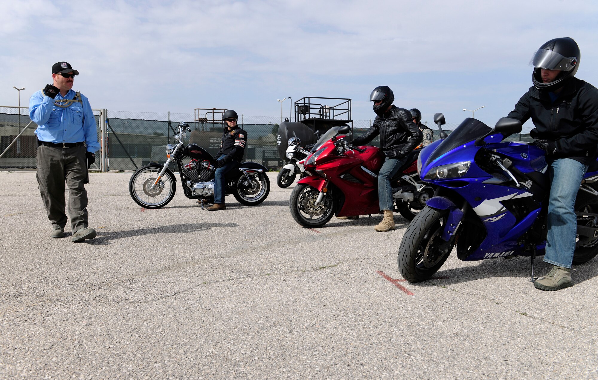 Master Sgt. Scott Fasulo, motorcycle safety instructor, indicates for Basic Rider Course 2 students to turn off their motorcycles March 27, 2015, at Incirlik Air Base, Turkey. The students participated in the one-day course in order to increase their riding proficiency. (U.S. Air Force photo by Senior Airman Krystal Ardrey/Released)