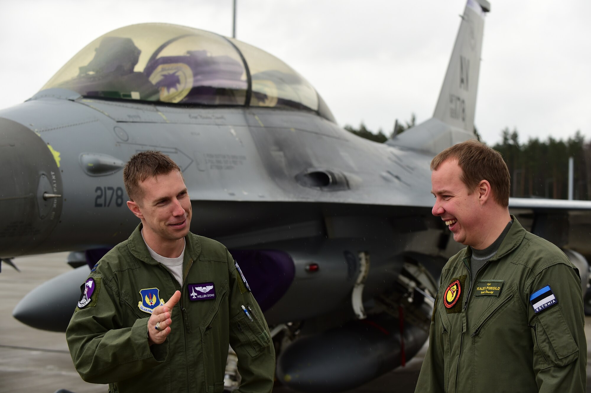 U.S. Air Force Capt. Thomas Dowd and Capt. Kalev Piirisild, Amari FTD project officers for the U.S. and Estonia, respectively, converse in front of an F-16 Fighting Falcon at Ämari Air Base, Estonia on April 1, 2015. At the invitation of the Estonian government, approximately 300 U.S. personnel from the 31st Fighter Wing are participating in bilateral training with Estonians to maintain joint readiness while building interoperability capabilities. (U.S. Air Force photo by Tech. Sgt. Chrissy Best/Released)
