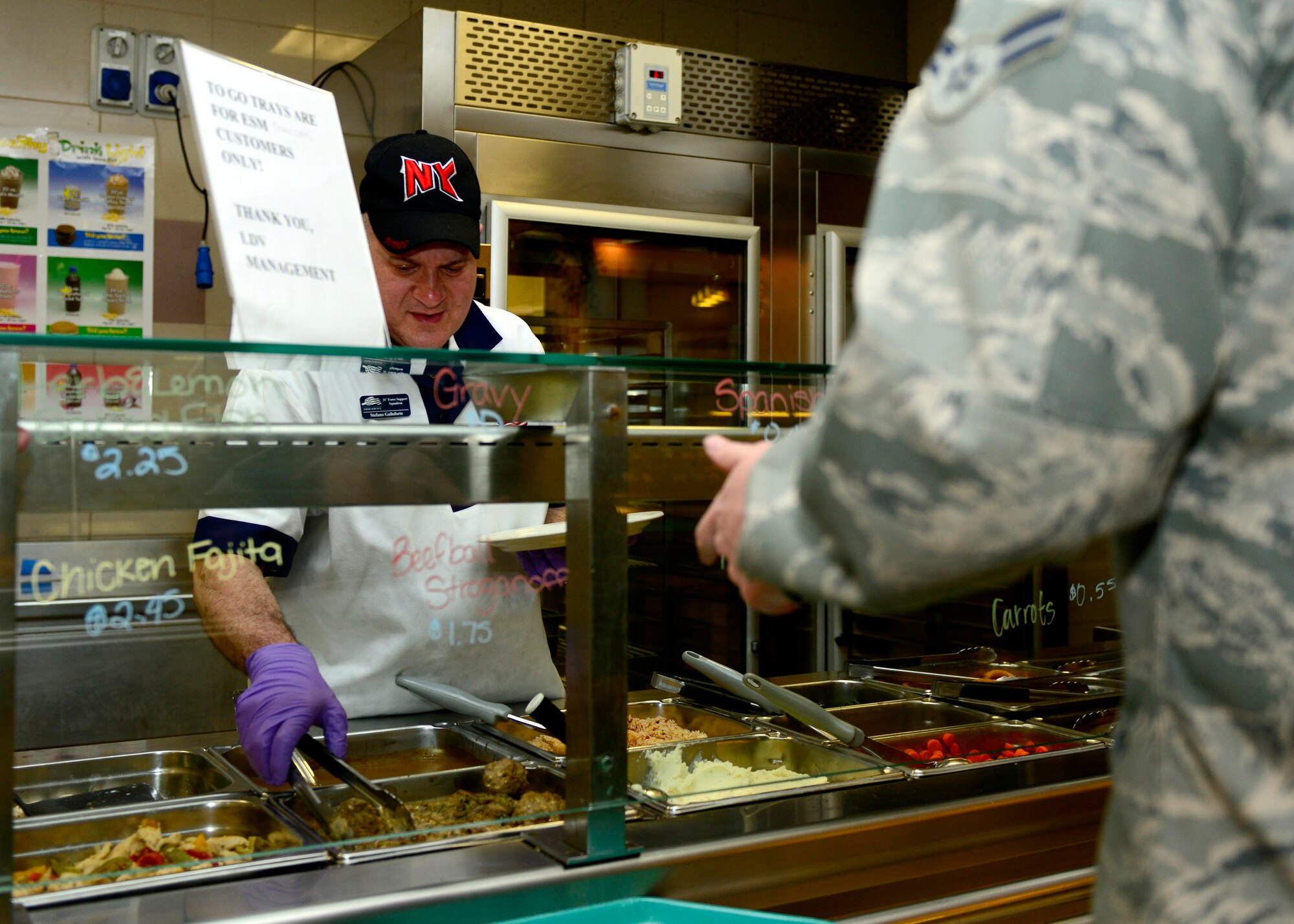 Stefano Galloforte, 31st Force Support Squadron cook and cashier, serves lunch, April 1, 2015, at Aviano Air Base, Italy. In addition to providing hot meals for Airmen, La Dolce Vita also hosts numerous distinguished visitor visits throughout the year. (U.S. Air Force photo by Senior Airman Areca T. Wilson/Released)