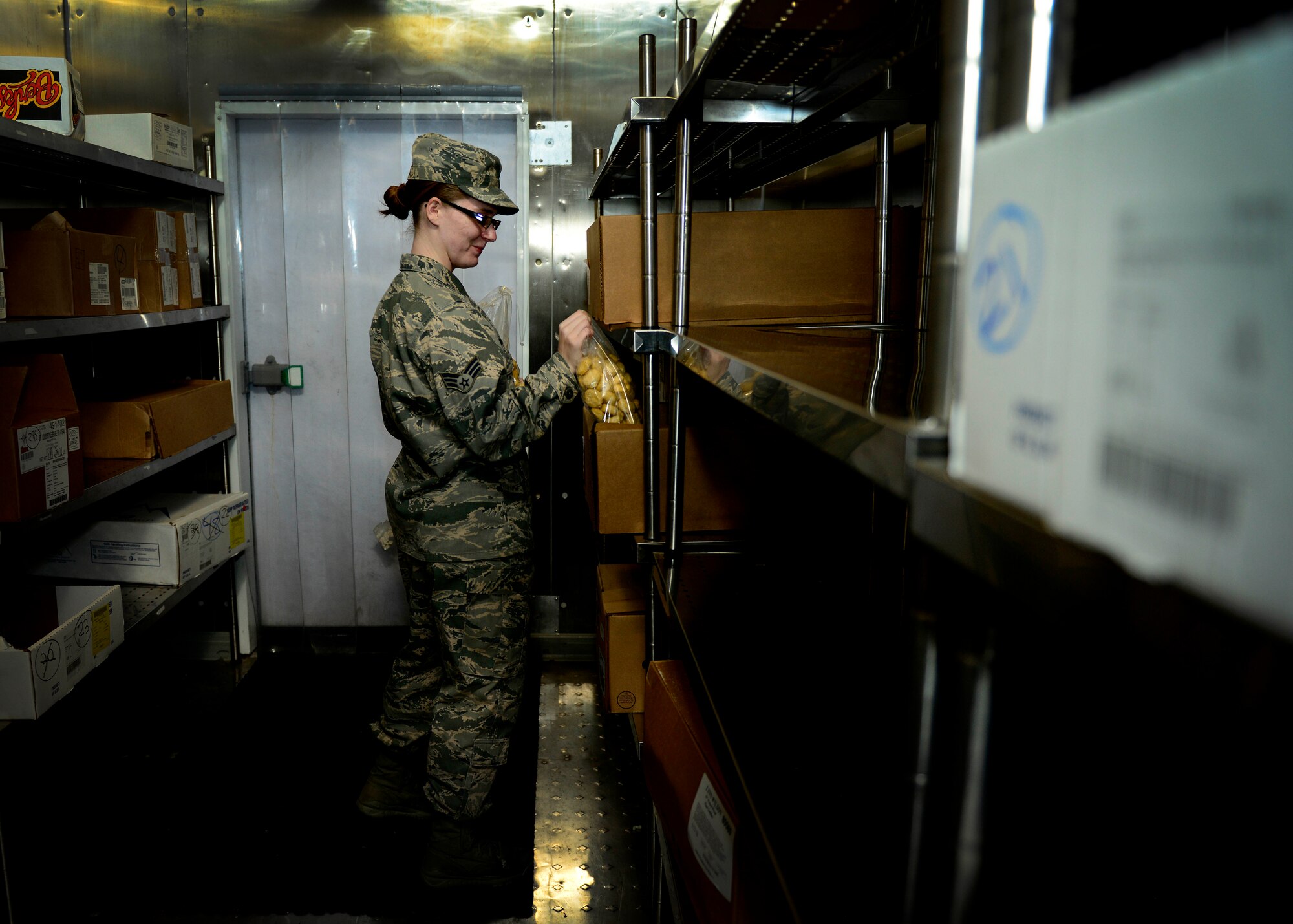 U.S. Air Force Senior Airman Angela Bowles, 31st Force Support Squadron food services journeyman, gathers ingredients before preparing lunch, April 1, 2015, at Aviano Air Base, Italy. La Dolce Vita provides four meals to an average of 550 guests per day. (U.S. Air Force photo by Senior Airman Areca T. Wilson/Released)