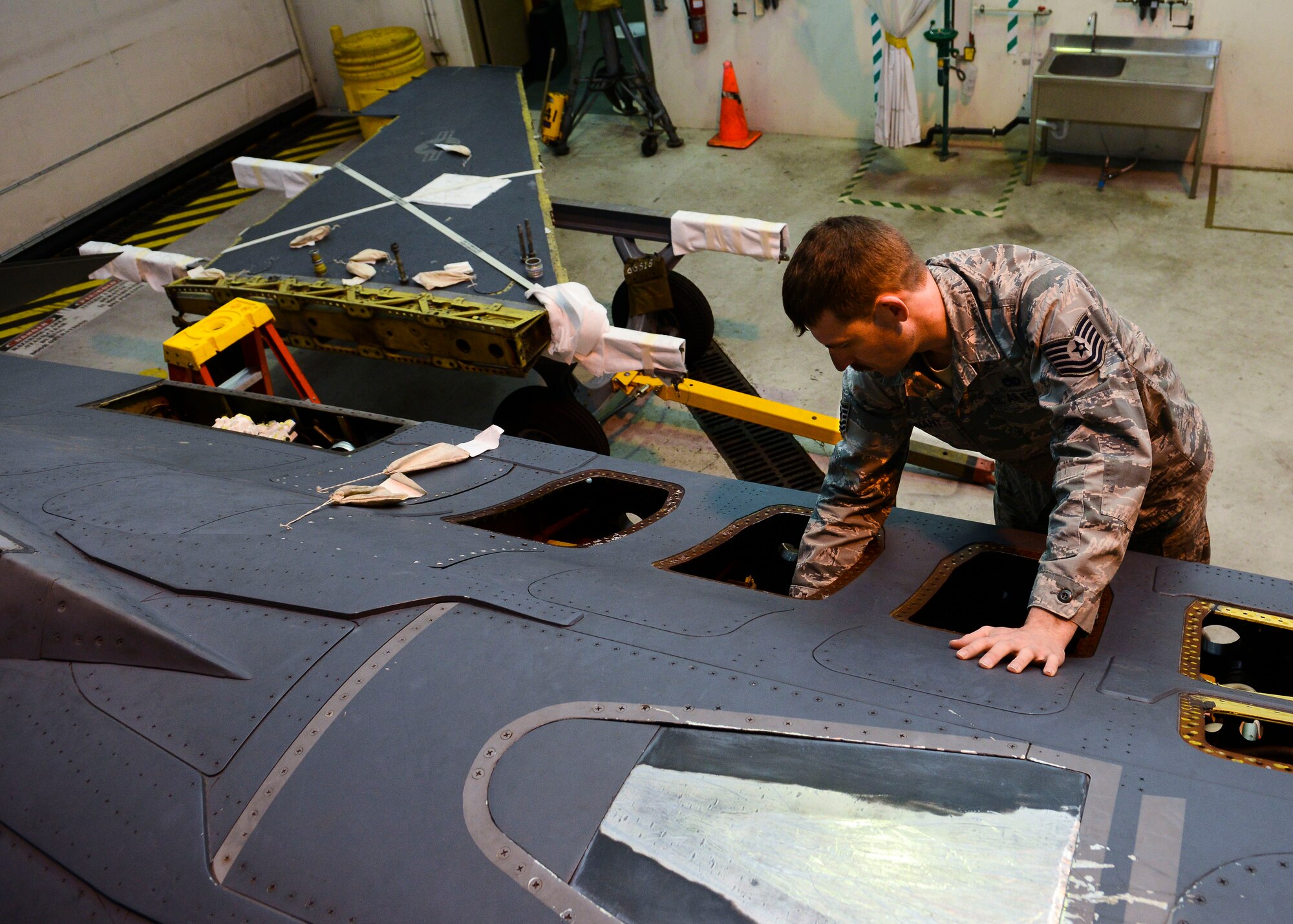 U.S. Air Force Tech. Sgt. Donald Hannant, 31st Maintenance Squadron assistant flight chief, checks F-16 Fighting Falcon connection points, March 31, 2015, at Aviano Air Base, Italy. After a wing on a jet comes off, multiple maintenance career fields come together to inspect the aircraft for damage. (U.S. Air Force photo by Senior Airman Austin Harvill/Released)