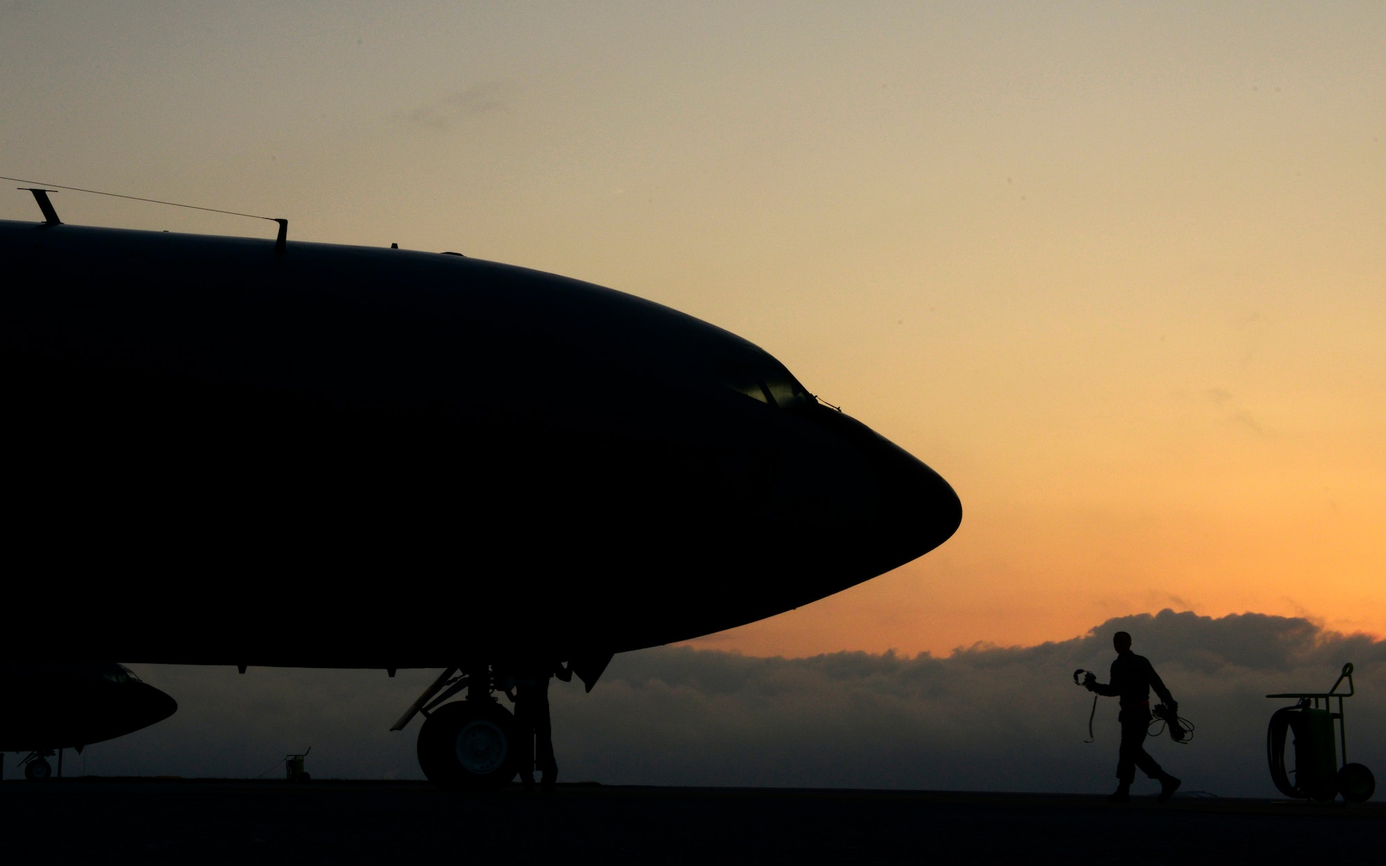 A U.S. Air Force Airman from the 909th Aircraft Maintenance Unit walks toward a 909th Air Refueling Squadron KC-135 Stratotanker refueling aircraft during  the Forceful Tiger exercise on Kadena Air Base, Japan, April 1, 2015. The Stratotankers allowed approximately 50 aircraft to stay airborne during the exercise for more than four hours by keeping them fueled. (U.S. Air Force photo by Staff Sgt. Maeson L. Elleman)