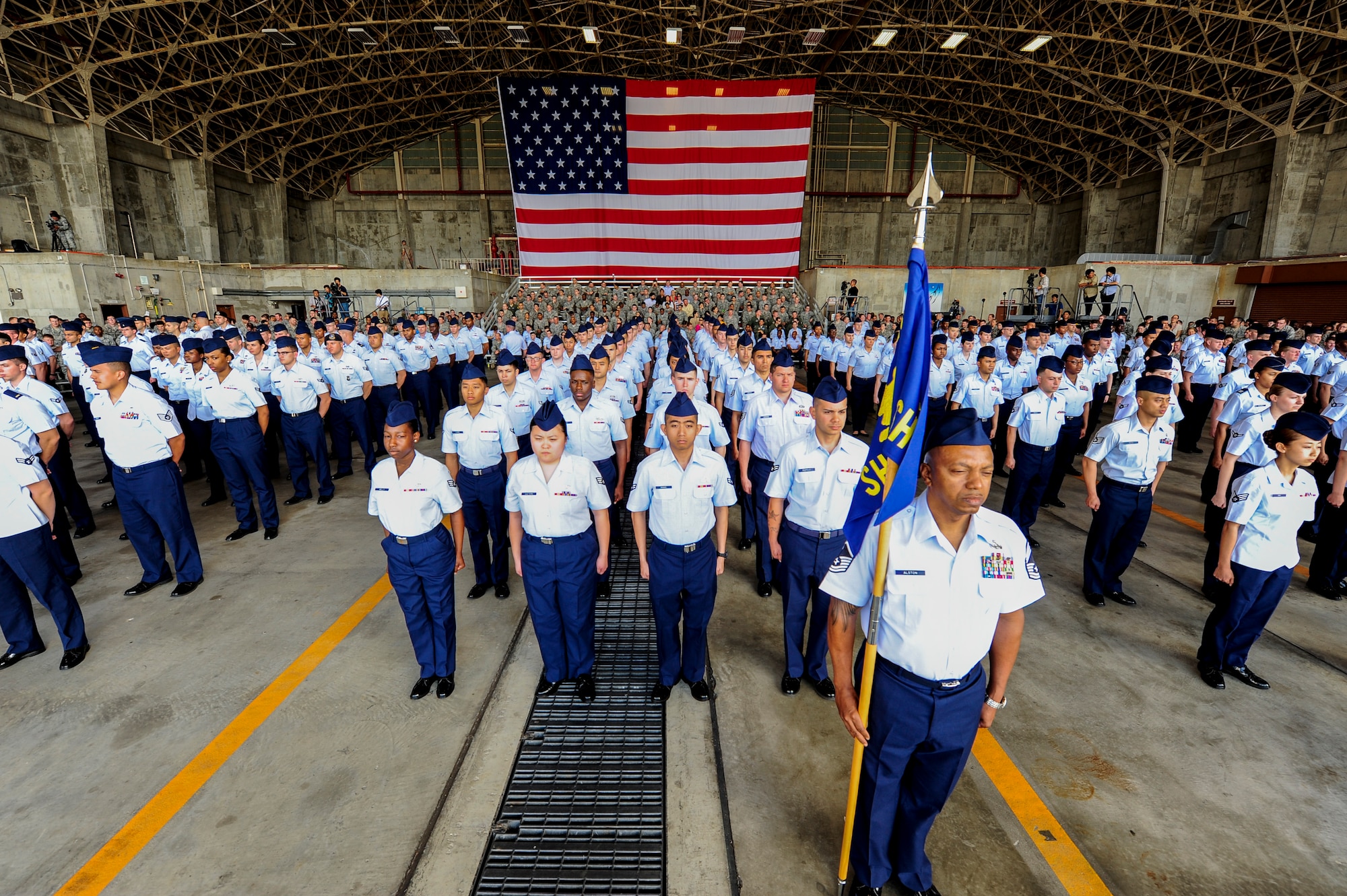 U.S. Air Force Airmen from the 18th Wing stand at attention during the 18th Wing change of command ceremony on Kadena Air Base, Japan, April 2, 2015. During the ceremony, command of the 18th Wing was relinquished by Brig. Gen. James Hecker and passed to Brig. Gen. Barry Cornish, who will serve as the wing commander for the next two years. (U.S. Air Force photo by Airman 1st Class John Linzmeier)