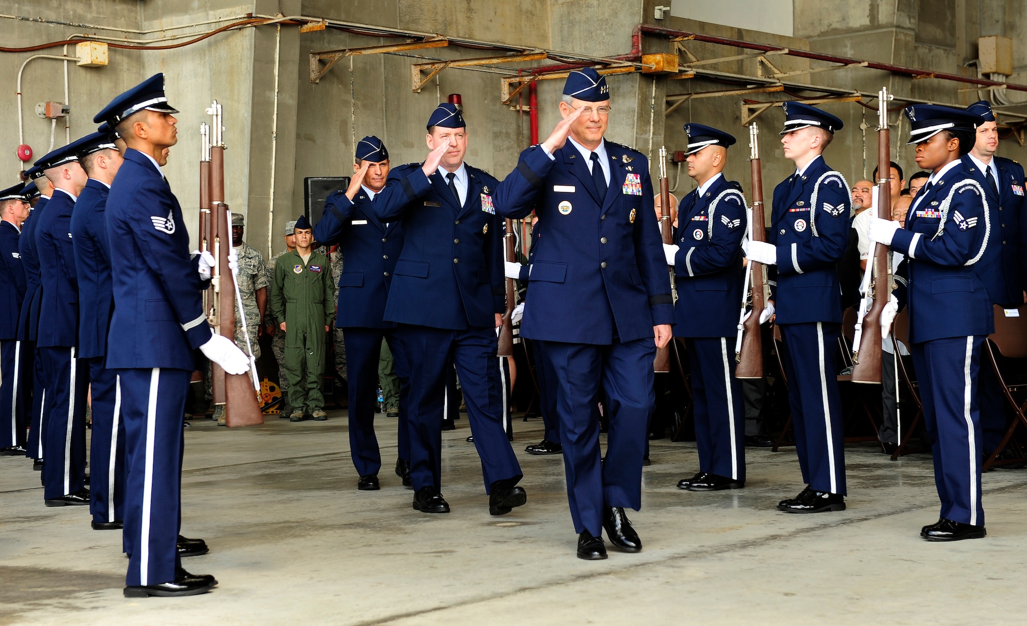 U.S. Air Force Lt. Gen. Sam Angelella, 5th Air Force and U.S. Forces Japan commander, Brig. Gen. James Hecker and Brig. Gen. Barry Cornish salute as they pass between rows of Kadena Honor Guard members during the 18th Wing change of command ceremony on Kadena Air Base, Japan, April 2, 2015. During the ceremony, command of the 18th Wing was relinquished by Hecker and passed to Cornish, who will serve as the wing commander for the next two years. (U.S. Air Force photo by Airman 1st Class John Linzmeier)
