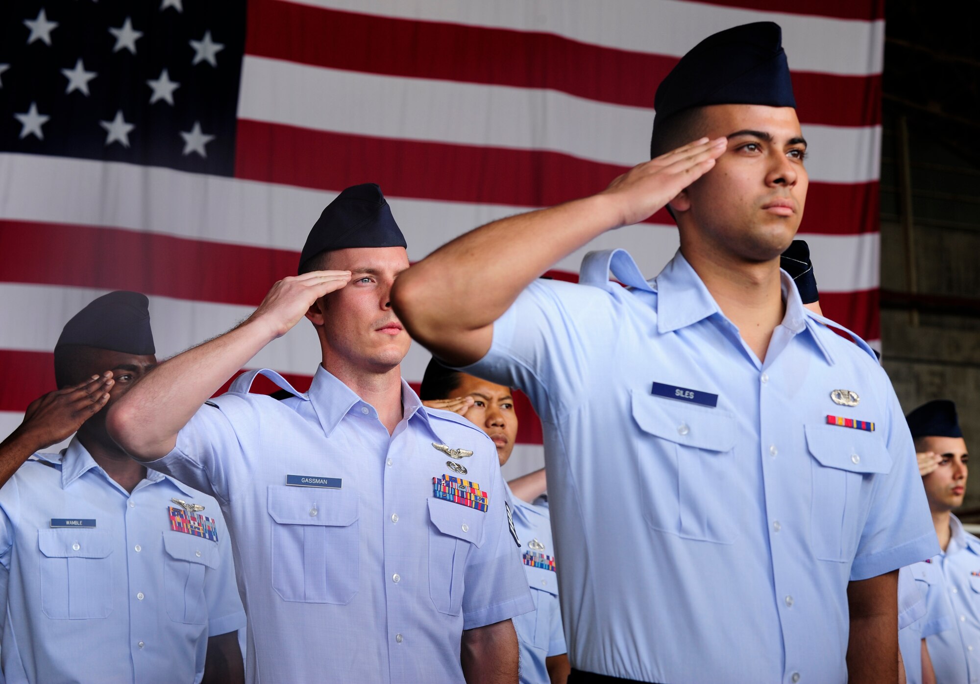 U.S. Air Force Airmen representing the different groups under the 18th Wing render salutes for the first time to their new commander, Brig. Gen. Barry Cornish during the 18th Wing change of command ceremony on Kadena Air Base, Japan, April 2, 2015. During the ceremony, Brig. Gen. James Hecker relinquished command of the wing as he continues his Air Force career as the director of plans, programs, and requirements, Headquarters Air Combat Command, Joint Base Langley-Eustis, Va. (U.S. Air Force photo by Airman 1st Class John Linzmeier) 