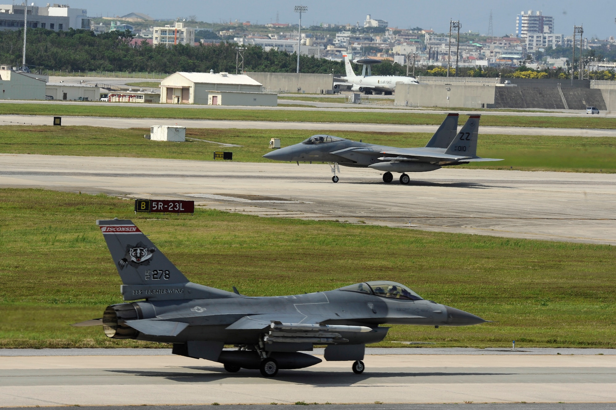 A U.S. Air Force F-16 Fighting Falcon from the Wisconsin Air National Guard 115th Fighter Wing and an F-15C Eagle from the 67th Fighter Squadron taxi on the flightline of Kadena Air Base, Japan, during  Exercise Forceful Tiger April 1, 2015. The exercise allowed the pilots to train alongside multiple aircraft including KC-135 Stratotankers from the 909th Air Refueling Squadron, E-3 Sentry from the 961st Airborne Air Control Squadron and F-16 Fighting Falcons from the Wisconsin Air National Guard 176th Fighter Squadron, in various scenarios, increasing their combat readiness. (U.S. Air Force photo by Staff Sgt. Marcus Morris)