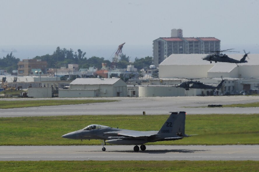 A U.S. Air Force F-15C Eagle from the 67th Fighter Squadron and two HH-60G Pave Hawk helicopters from the 33rd Rescue Squadron land during  the Forceful Tiger exercise on Kadena Air Base, Japan, April 1, 2015. The exercise allowed the pilots to train alongside multiple aircraft including KC-135 Stratotankers from the 909th Air Refueling Squadron, E-3 Sentry from the 961st Airborne Air Control Squadron and F-16 Fighting Falcons from the Wisconsin Air National Guard 176th Fighter Squadron, in various scenarios, increasing their combat readiness. (U.S. Air Force photo by Staff Sgt. Marcus Morris)