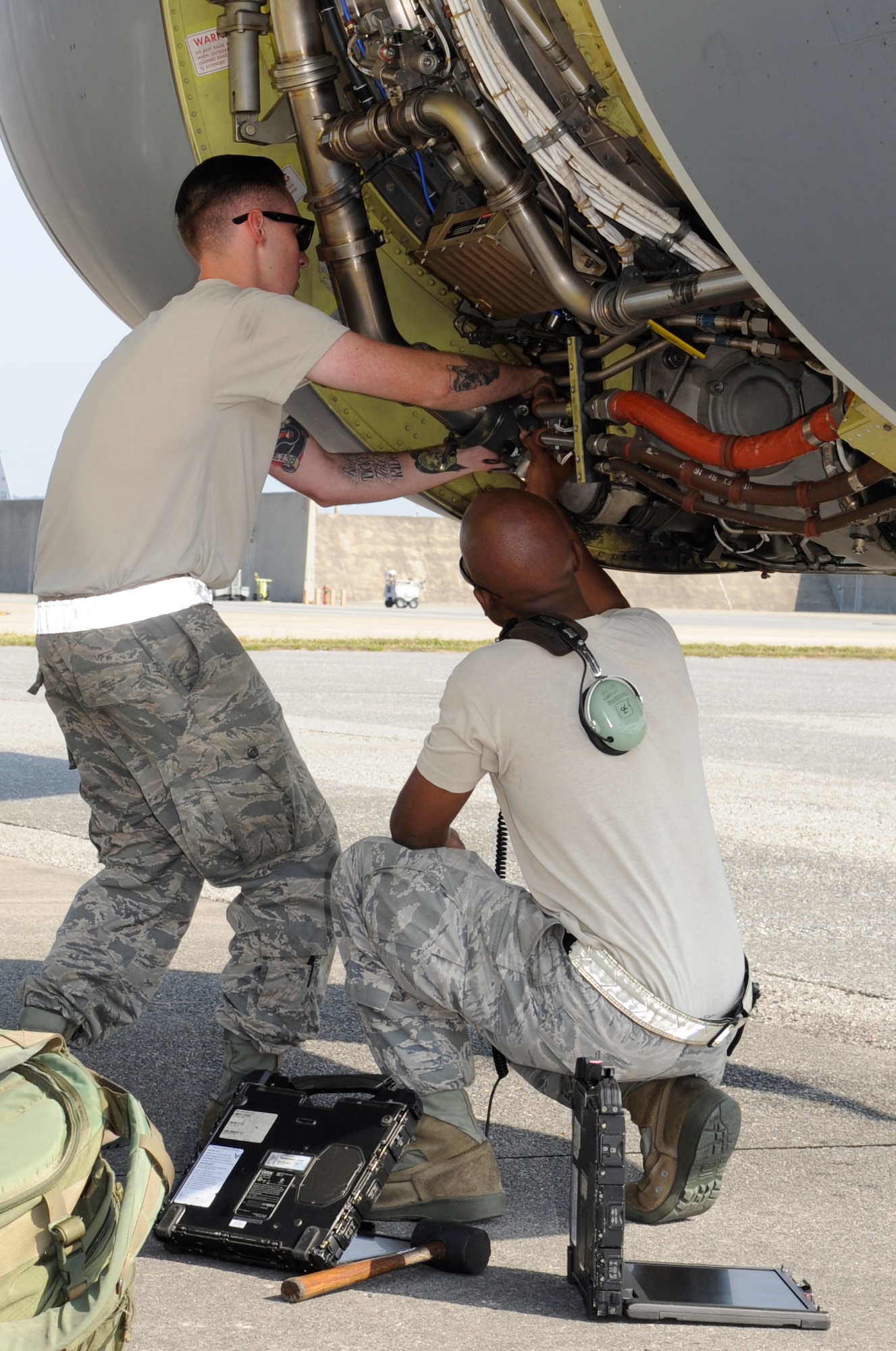 U.S. Air Force Senior Airman Ty Deprez (left) and Tech. Sgt. David Williams, both 718th Aircraft Maintenance Squadron aerospace propulsion technicians, replace a fire control valve on a 909th Air Refueling Squadron KC-135 Stratotanker engine during  the Forceful Tiger exercise on Kadena Air Base, Japan, April 1, 2015. The 718th AMXS maintains the Air Force’s only air refueling, combat search and rescue and air battle management assets in the Western Pacific region. (U.S. Air Force photo by Staff Sgt. Marcus Morris)