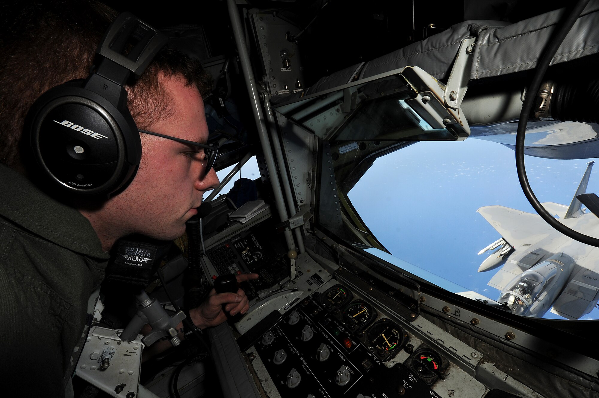 U.S. Air Force Senior Airman Justin Gillespie, 909th Air Refueling Squadron boom operator, refuels a U.S. Air Force F-15C Eagle from Kadena Air Base, Japan during  the Forceful Tiger exercise over the Pacific Ocean, April 1, 2015. KC-135 Stratotankers from the 909th ARS enabled 50 aircraft to stay airborne for more than four hours during the aerial exercise. (U.S. Air Force photo by Airman 1st Class Zade C. Vadnais)
