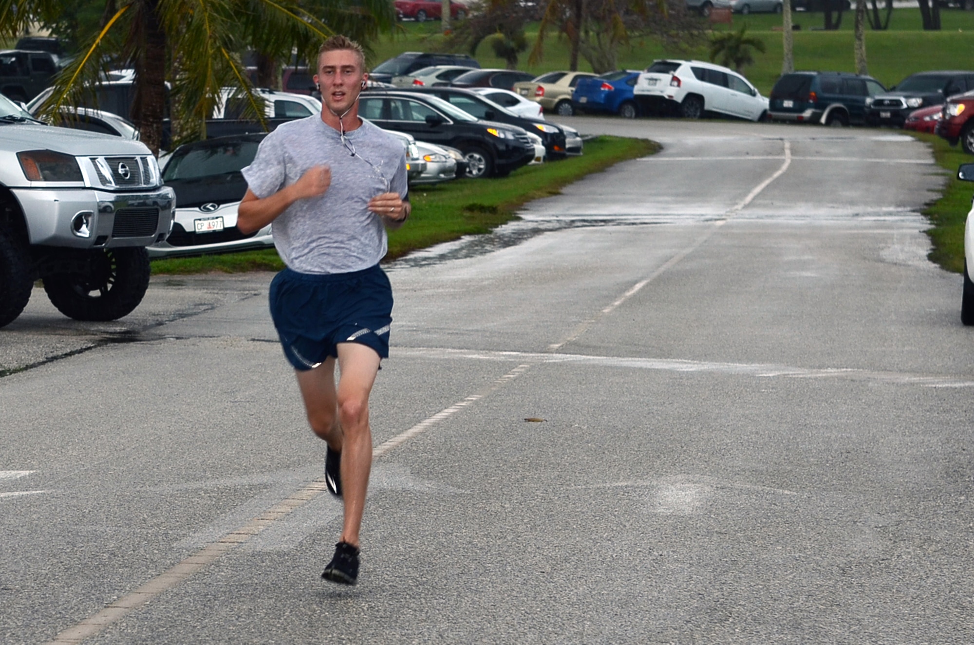 Jacob Johnson, 36th Munitions Squadron, sprints to the finish line during the April Fool’s 5K at the Palm Tree Golf Course on Andersen Air Force Base, Guam, April 1, 2015. Johnson was the first runner to cross the finish line with a time of 18:51. (U.S. Air Force photo by Airman 1st Class Alexa Ann Henderson/Released)