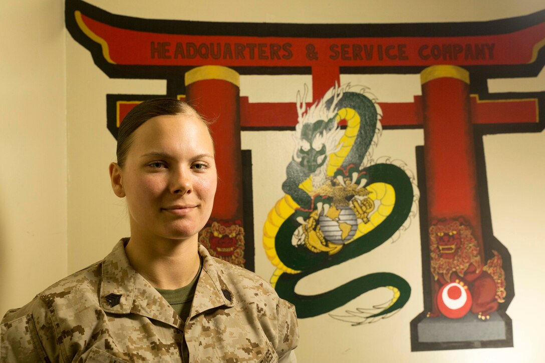 Sgt. Shelly Janecke, a self-made artist from Eaton Rapids, Michigan, redesigns the Headquarters and Service Company logo March 26 at Camp Courtney. She shows her passion of art through drawing, painting and designing tattoos. Janecke is the III Marine Expeditionary Force G-4 Materials Readiness Branch ammunition noncommissioned officer in charge with III MEF Headquarters Group, III MEF. 