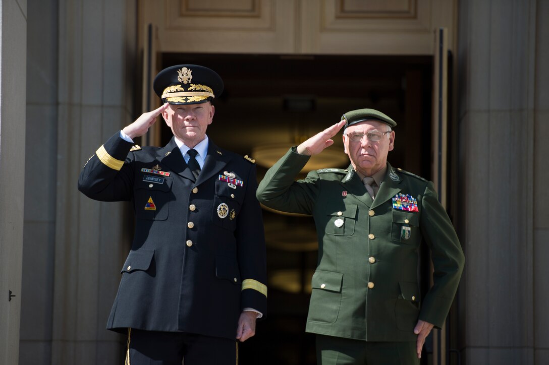 U.S. Army Gen. Martin E. Dempsey, left, chairman of the Joint Chiefs of Staff, and Brazilian Gen. Jose Carlos DeNardi, chief of the joint staff of Brazil's armed forces, salute in front of the Pentagon, April, 2, 2015.