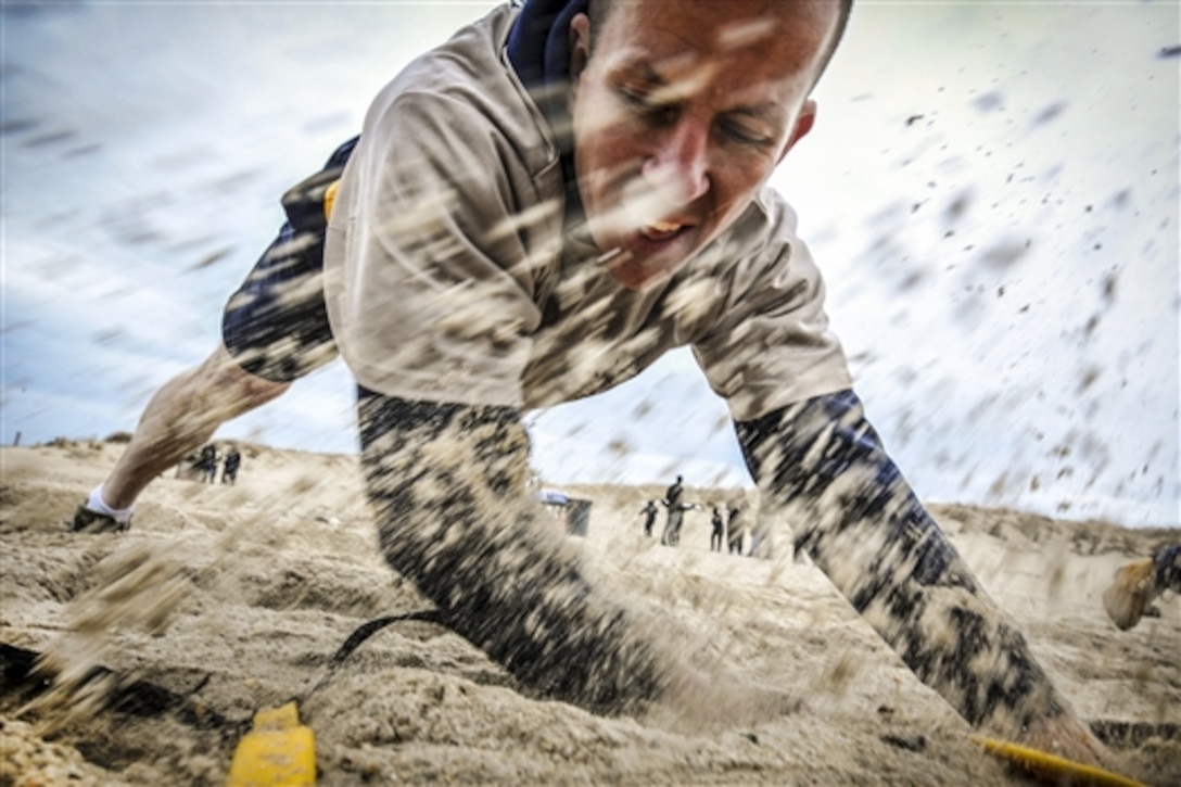 Navy Chief Petty Officer Alexander Thomas shuffles across an obstacle during the 2015 Goat Locker Challenge on Joint Expeditionary Base Little Creek-Fort Story in Norfolk, Va., March 30, 2015. The event commemorates the 122nd birthday of the rank of chief petty officer in the Navy. 