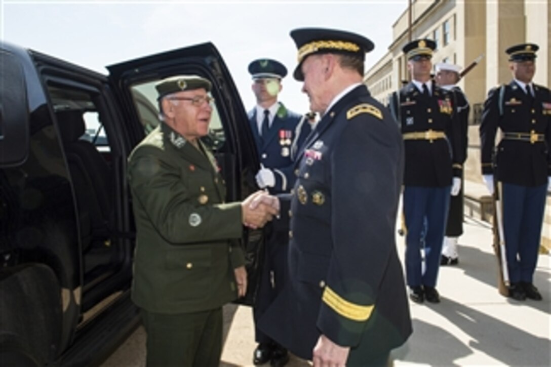 U.S. Army Gen. Martin E. Dempsey, right, chairman of the Joint Chiefs of Staff, greets Brazilian Gen. Jose Carlos DeNardi, chief of the joint staff of Brazil's armed forces, during an honor cordon at the Pentagon, April, 2, 2015. The two defense leaders met to discuss matters of mutual importance.