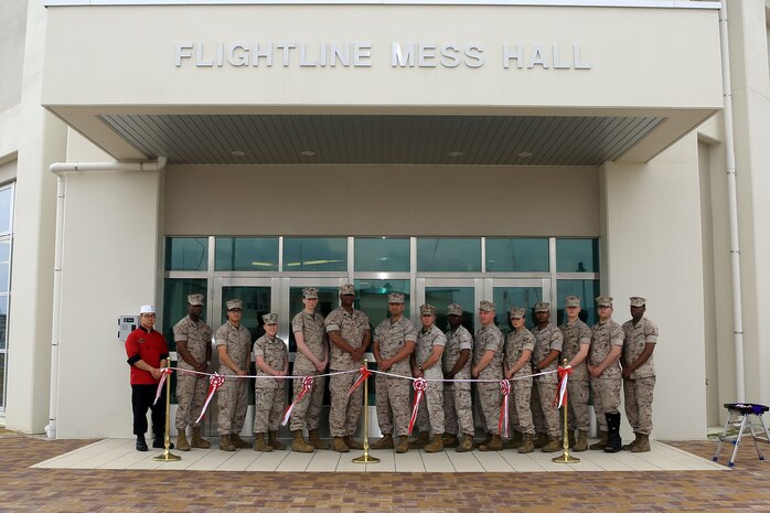 Food service specialists with Headquarters and Headquarters Squadron pose outside the Flightline Mess Hall before the ribbon cutting ceremony, April 1, 2015, aboard Marine Corps Air Station Iwakuni, Japan. As part of the Defense Policy Review Initiative aboard station, the opening of the new Mess Hall will improve proficiency of the flightline by providing Marines a closer facility to enjoy chow.