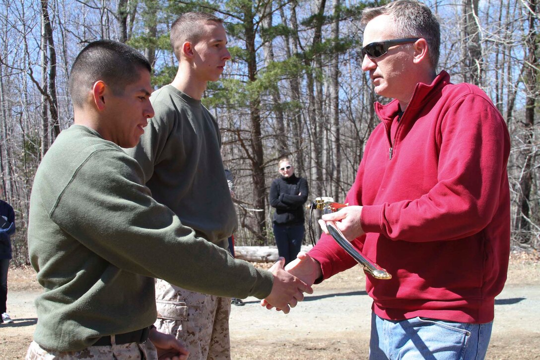 Retired U.S. Marine Corps Capt. John French, right, a former officer selection officer, presents a Mameluke sword to U.S. Marine Corps 2nd Lt. Ronald Lima March 28, 2015, at Marine Corps Base Quantico, Virginia, for becoming one of Officer Selection Office Fairfax’s Applicants of the Year. French was the OSO for Hyattsville, Maryland, from 1994-1996. (U.S. Marine Corps photo by Sgt. Anthony J. Kirby/Released)