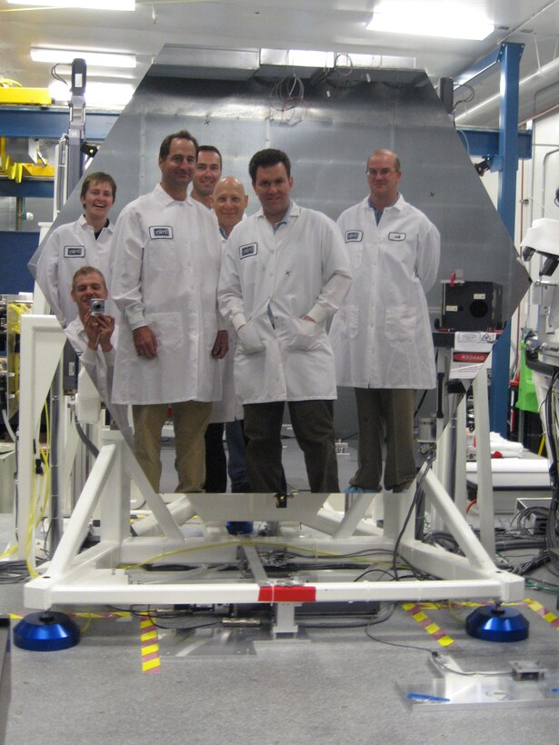 NASA scientist take a picture of themselves in a prototype 1.4 meter diameter beryllium mirror for the James Webb Space Telescope, September 2008.  (Photo courtesy of NASA.gov)