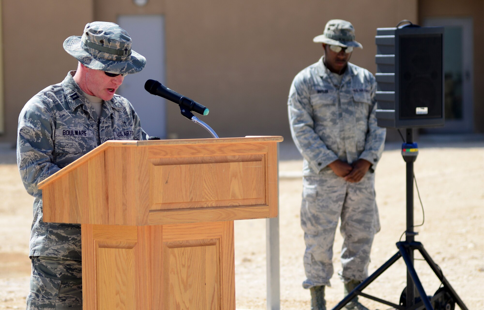 U.S. Air Force Capt. John Boulware, 379th Air Expeditionary Wing chaplain, gives the invocation during a linen cutting ceremony, April 3, 2015, at Al Udeid Air Base, Qatar. The linen cutting ceremony symbolized the opening of the new Phase II dormitories in the Blatchford-Preston Complex. (U.S. Air Force photo by Senior Airman Kia Atkins)